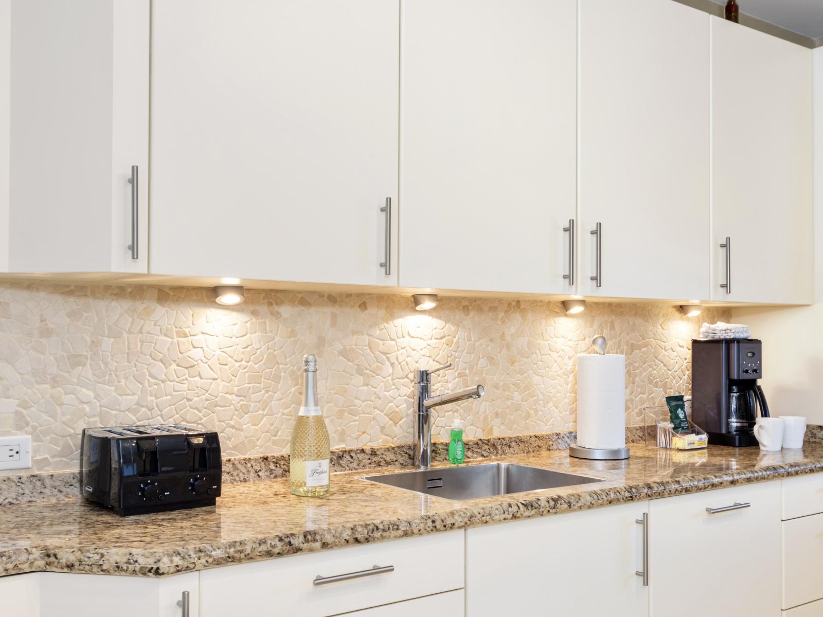 Modern Kitchen of the Villa in Noord Aruba - Kitchen with Modern Appliances - Contemporary design with clean lines and minimalist aesthetics - Light streaming in, enhancing the overall ambiance