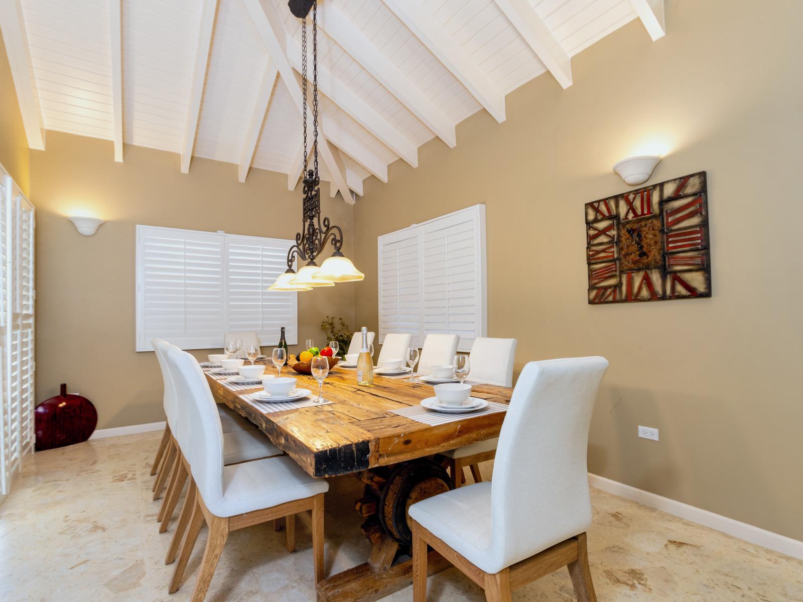 Charming Dining Area of the Villa in Noord Aruba - 8 Persons Dining - Quality materials, such as a sleek dining table and comfortable chairs - Modern Design - Intimate ambiance created through soft, ambient lighting