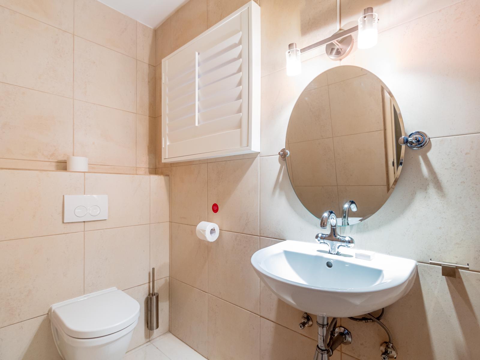 Elegant Half bathroom of the Villa  - Sink with upscale lighting - Neat and clean toilet