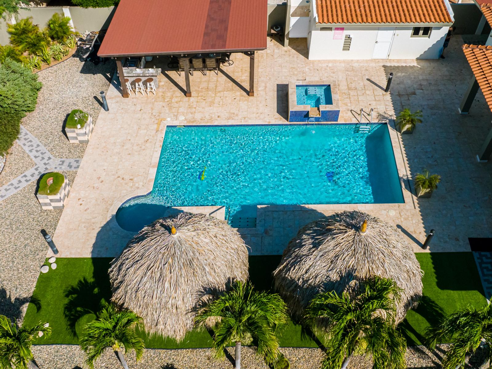 Captivating Pool Area of the Villa in Noord Aruba - A spot for friends and family to gather and socialize - Palm trees and tropical plants enhance the vacation feel - Bird-eye View