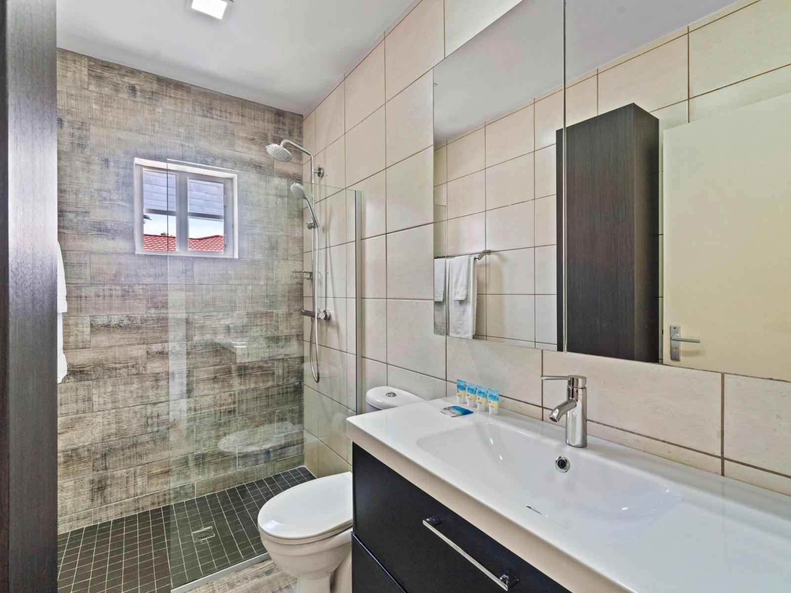 Enjoy the convenience of a walk-in shower in the third bedroom's bathroom, designed for ease and comfort.