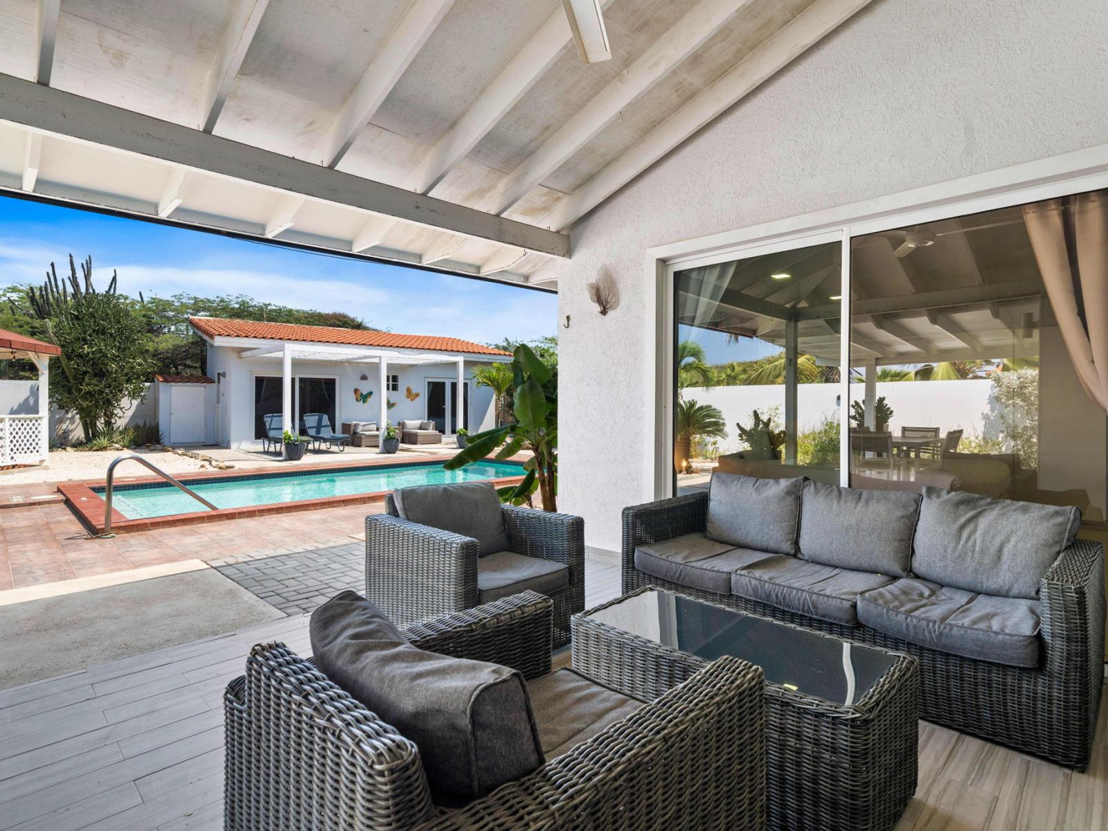 Large glass sliding doors connecting the living area to the backyard