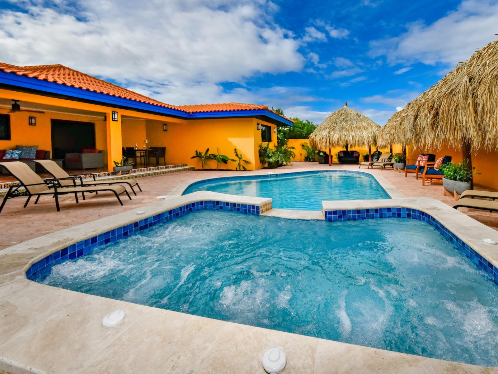 Resplendent Pool Area of the 4BR House in Noord Aruba - Fencing or greenery for a secluded feel - Provides a relaxed atmosphere for unwinding - Space for swimming, games, and activities - Poolside chairs perfect for sunbathing and relaxation