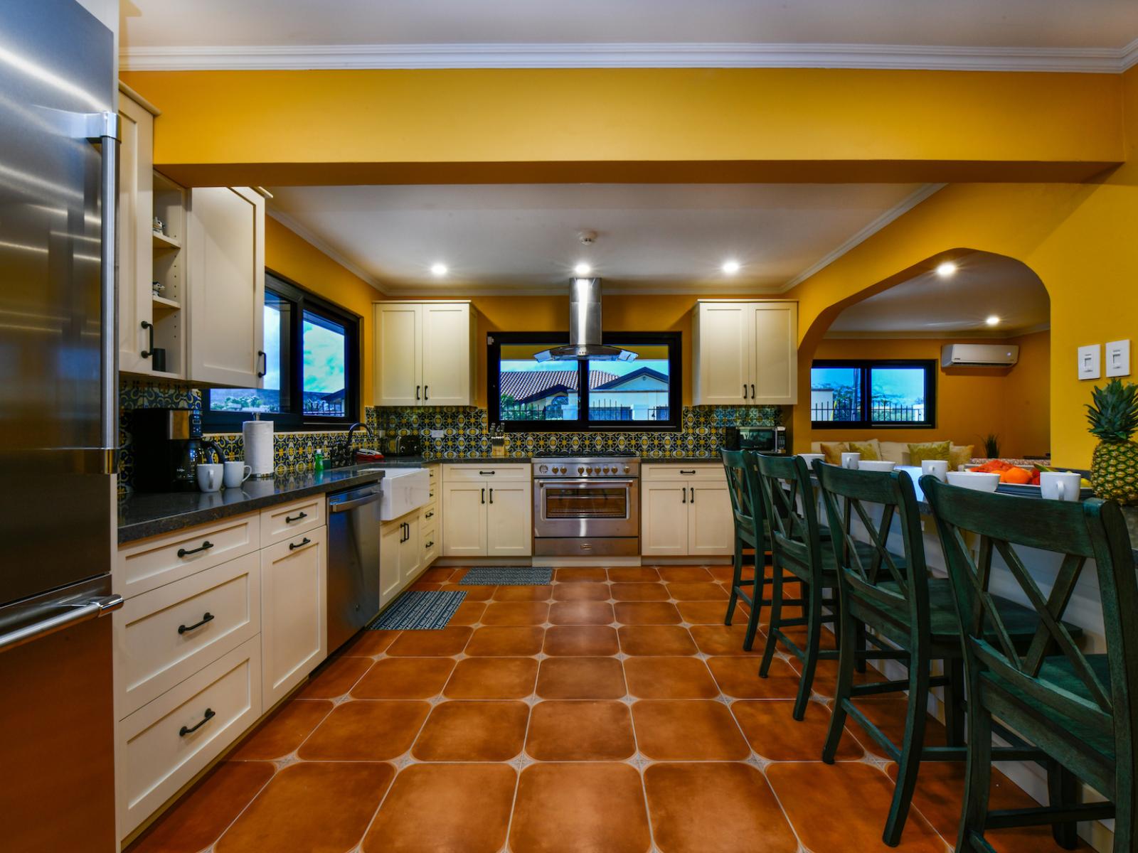 Resplendent Kitchen Area of the 4BR House in Noord Aruba - Personalized touches, such as decorative tiles  - Aesthetic cohesion with matching hardware and fixtures - Open shelving for easy access to frequently used items