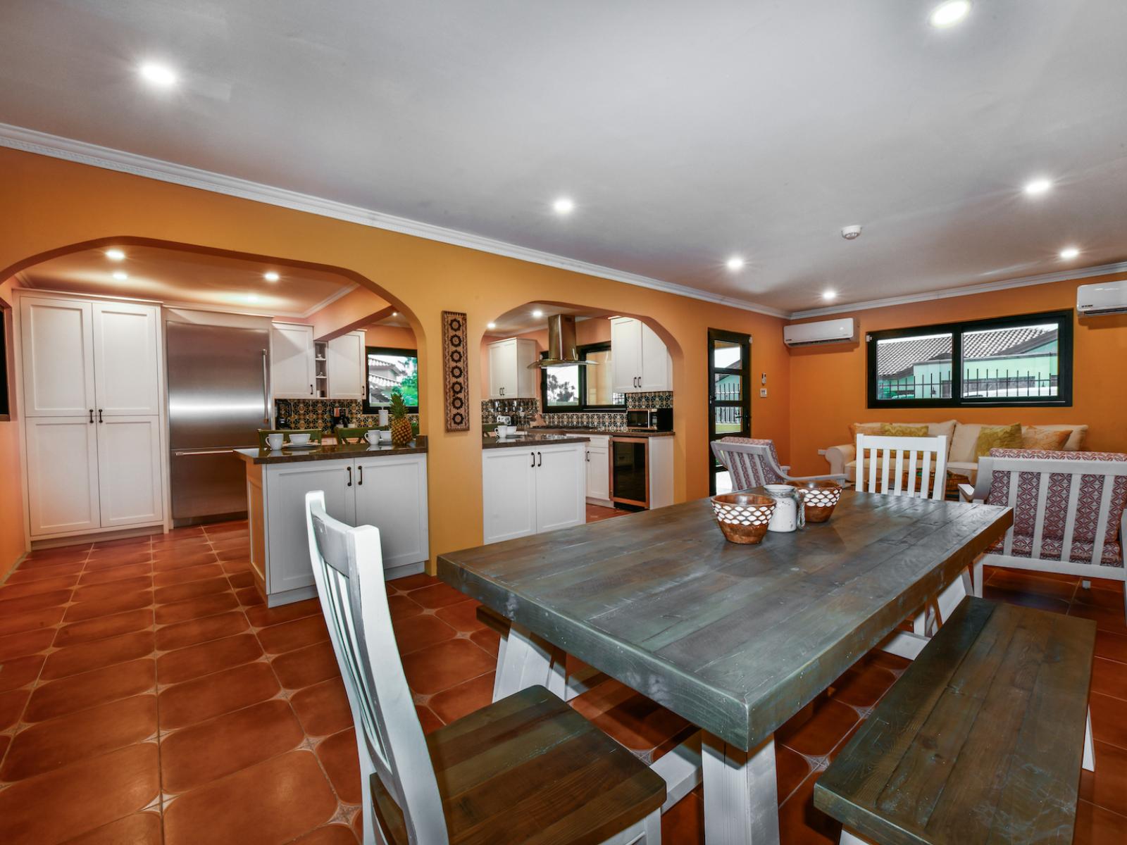 Inviting Dining Area of the 4BR House in Noord Aruba - Sophisticated design with a blend of modern and classic elements - Beautifully crafted dining table. - Flexible seating arrangements for diverse dining needs. - Access to outdoor dining option