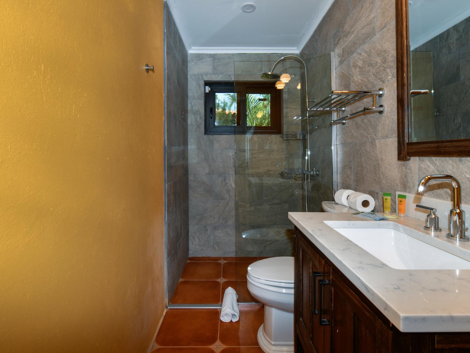 The second bedroom's bathroom offers a rejuvenating retreat with its modern walk-in shower.