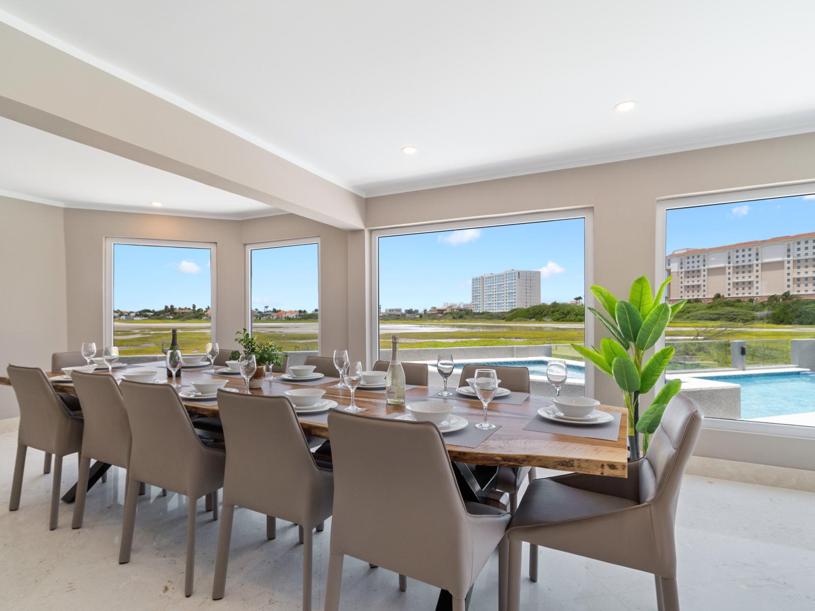 Magnificent Dining Area of the Villa in Noord Aruba  - 12 Persons dining - Stunning outside views - Cohesive design aesthetic carried through from furniture to window treatments - Experience breathtaking views via windows, welcoming natural light