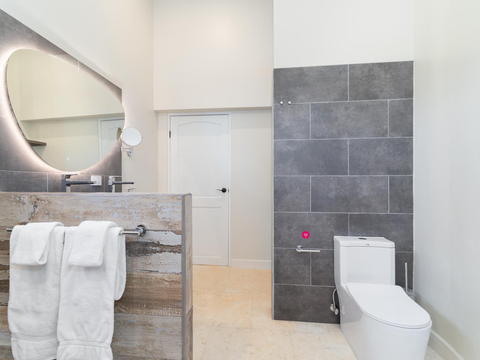 Opulent Bathroom of the Villa in Noord Aruba - Walk in shower - Chic Vanity with stylish Mirror - Attention to detail, from the elegant tiles to the faucets - Modern finishes