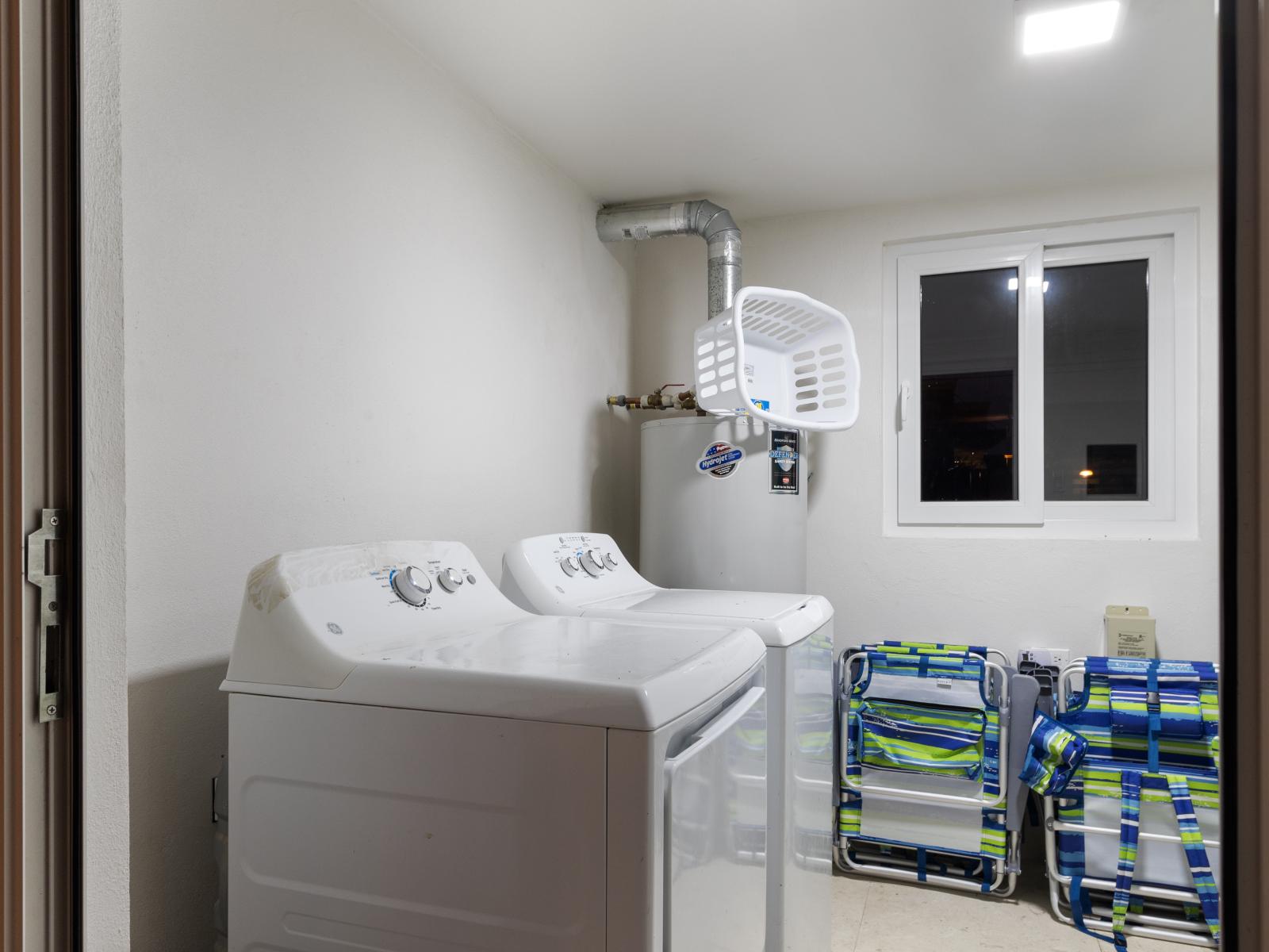 Clean laundry room of the apartment in Noord Aruba - Step into our laundry room - Equipped with a washer and dryer - Chores become a breeze amidst convenience and comfort - Beach Chairs