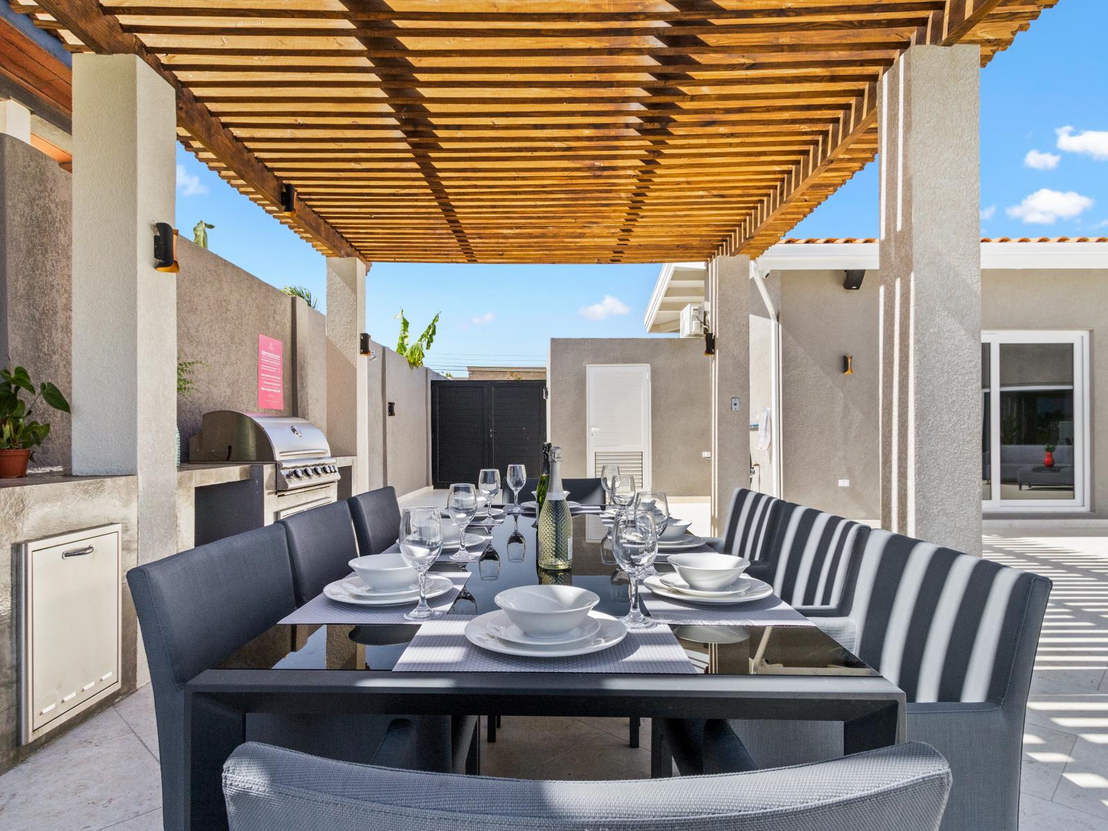 Elegant Outdoor Dining Area of the Villa in Noord Aruba - Savor the flavors of paradise with a side of poolside serenity - Outdoor dining experience offers a feast for the senses - 8 Persons Dining - Every meal accompanied by stunning pool views