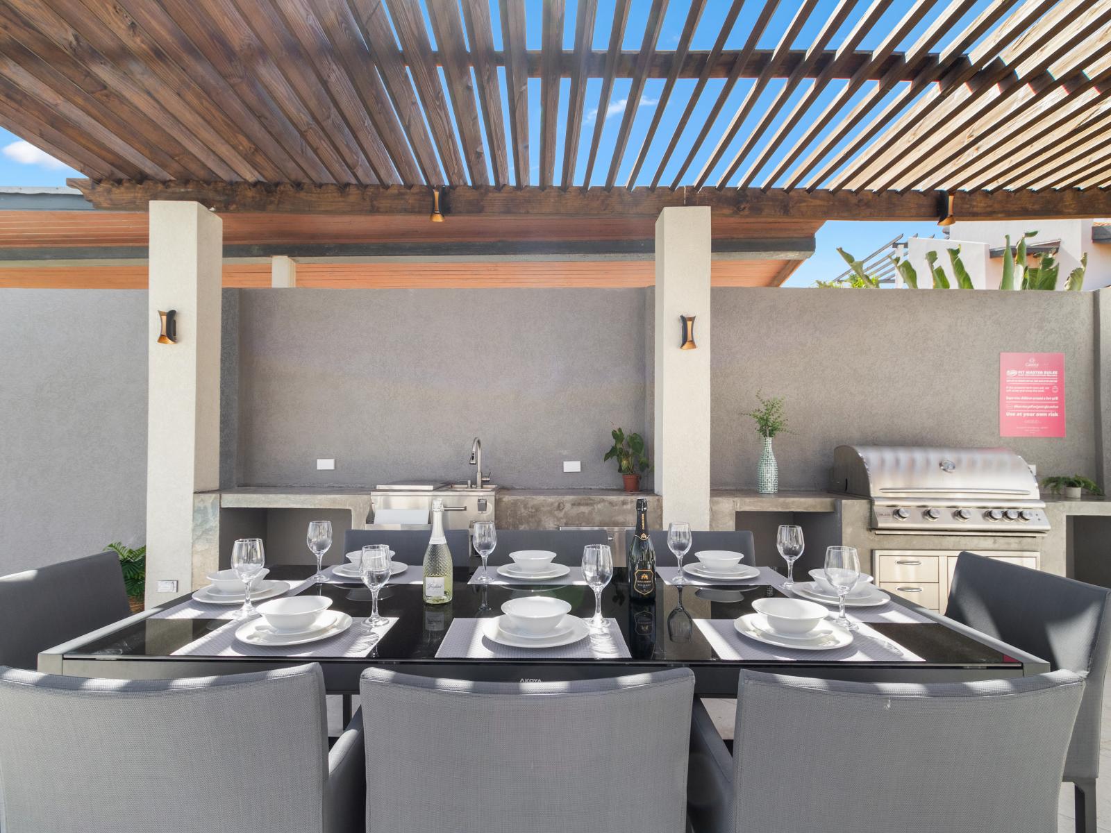 Elevate your dining experience with our outdoor kitchen and dining area, where culinary delights meet al fresco ambiance for memorable gatherings under the open sky.