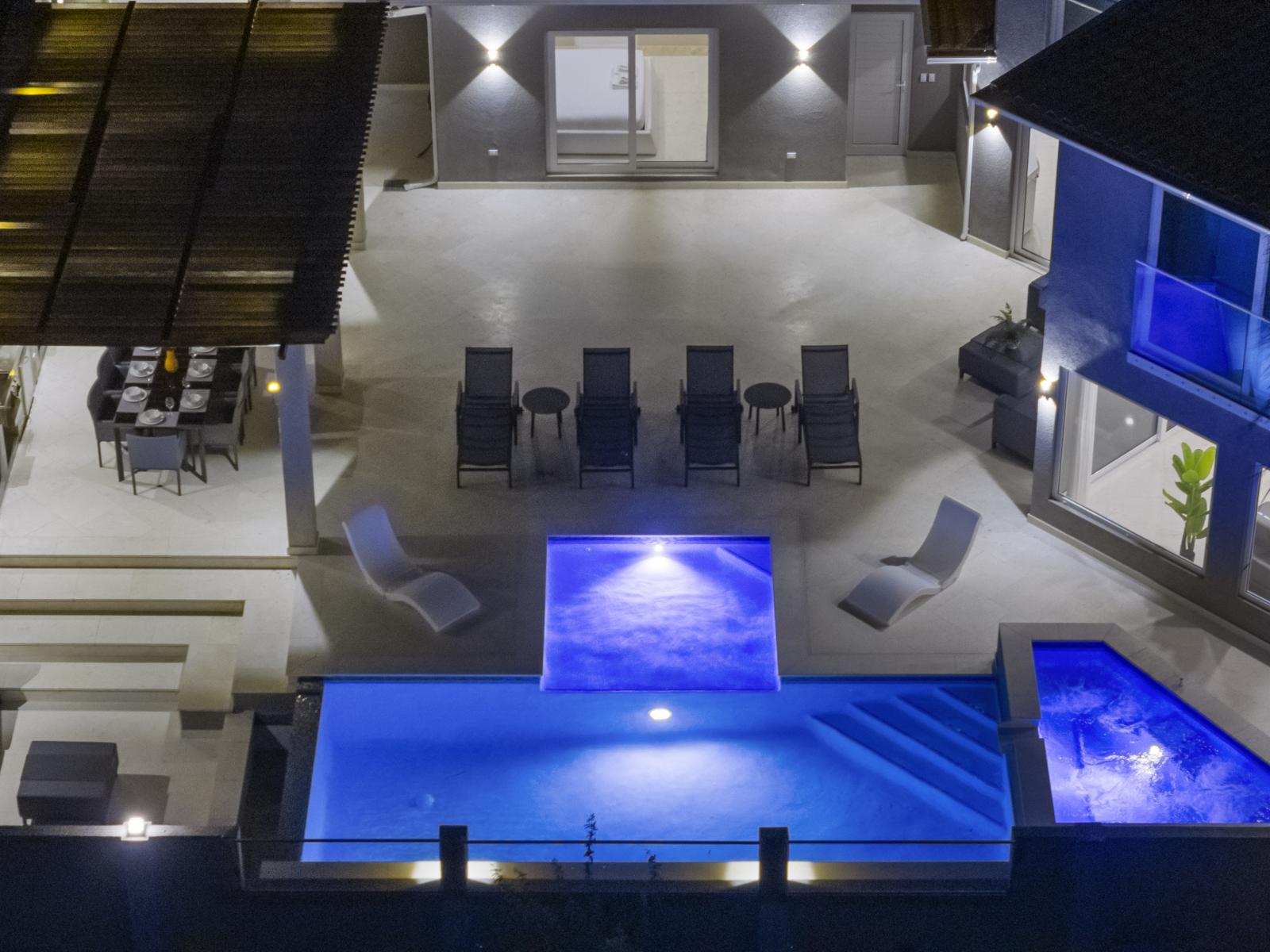 Inviting Pool Area of the Villa in Noord Aruba - Bird-eye view of the backyard - Relax by the shimmering poolside oasis - Thoughtful lighting for day and night use - Spacious Pool Area