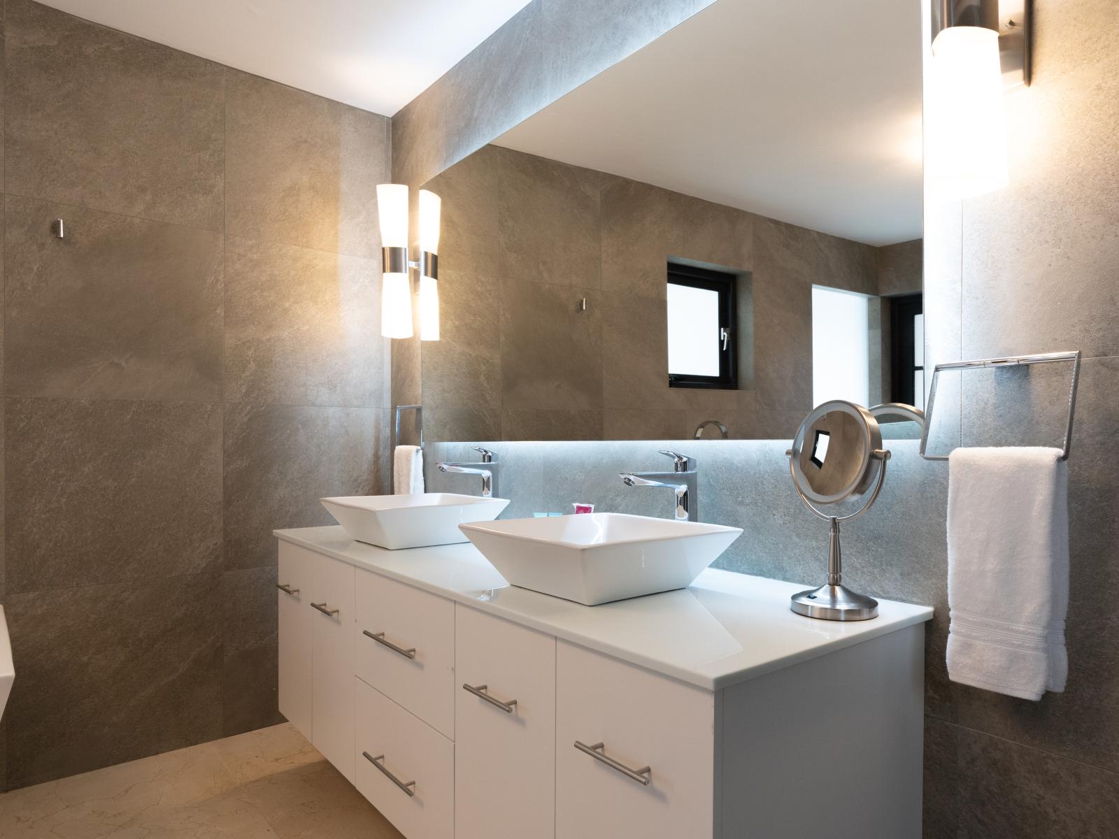 Elevate your morning routine in Bathroom 1, featuring a stylish double vanity. With ample space for two, getting ready becomes a breeze in this elegant sanctuary.