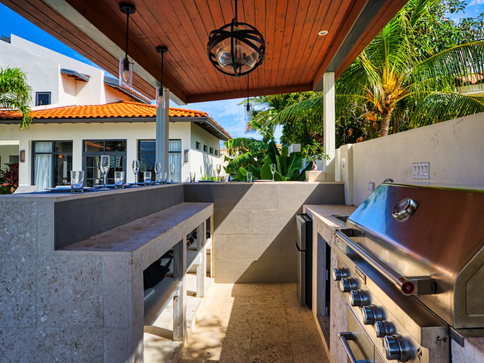 Stunning Outdoor Kitchen of the villa in Noord Aruba - Natural light streaming in, enhancing the overall ambiance - Easy access for outdoor moments - Well-planned layout maximizing comfort and functionality