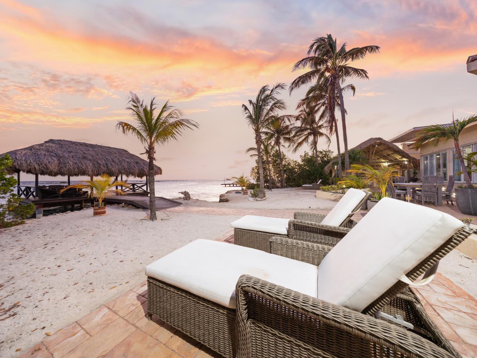 Lounging chairs on your private beach amidst the backdrop of tropical breezes and starlit skies.