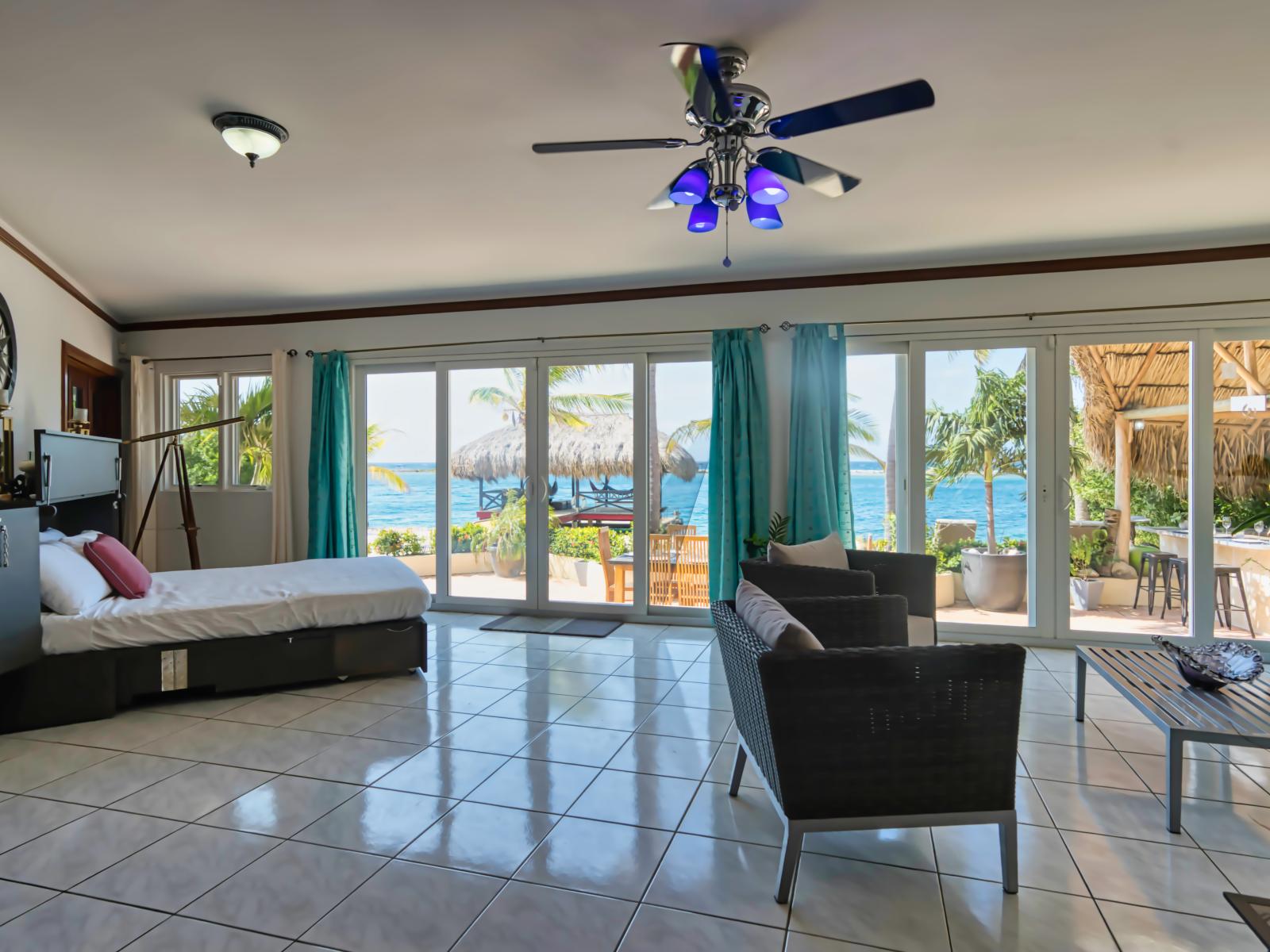 Spacious Bedroom of the Villa in Savaneta Aruba - Windows with Panoramic Views - Comfy Sofas - Smart TV and Netflix - Stunning Ocean Views