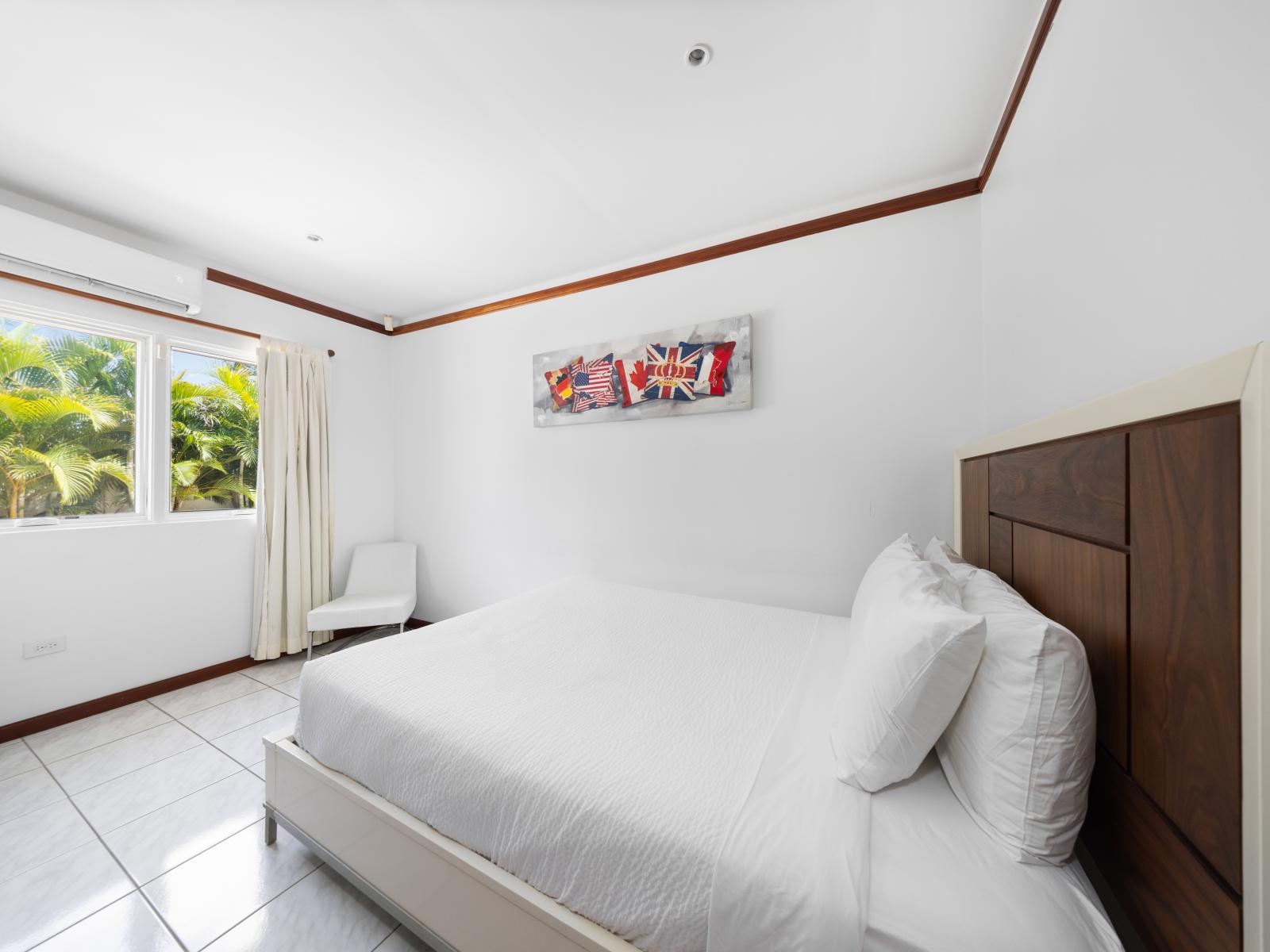 Experience comfort and relaxation in Bedroom 4 with a cozy queen-size bed