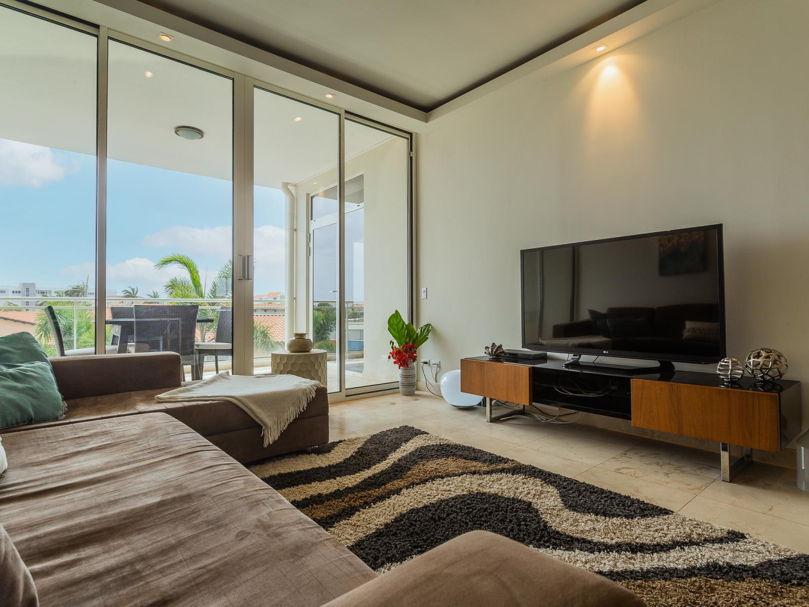 Magnificent Living Area of the lovely condo in Oranjestad Aruba - Smart TV and Netflix - Thoughtful mix of textures, from plush rugs to tasteful throw pillows - Cozy seating area conducive to relaxation and socializing - Well-chosen lighting fixtures