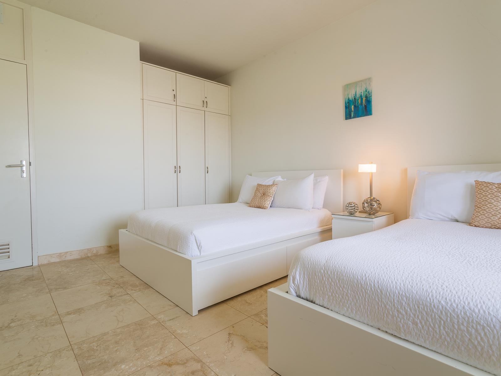 Relax and unwind in Bedroom 2, furnished with two full-size beds to accommodate your sleeping preferences. With soft linens and plenty of space to stretch out, this inviting room promises a peaceful stay for all guests.