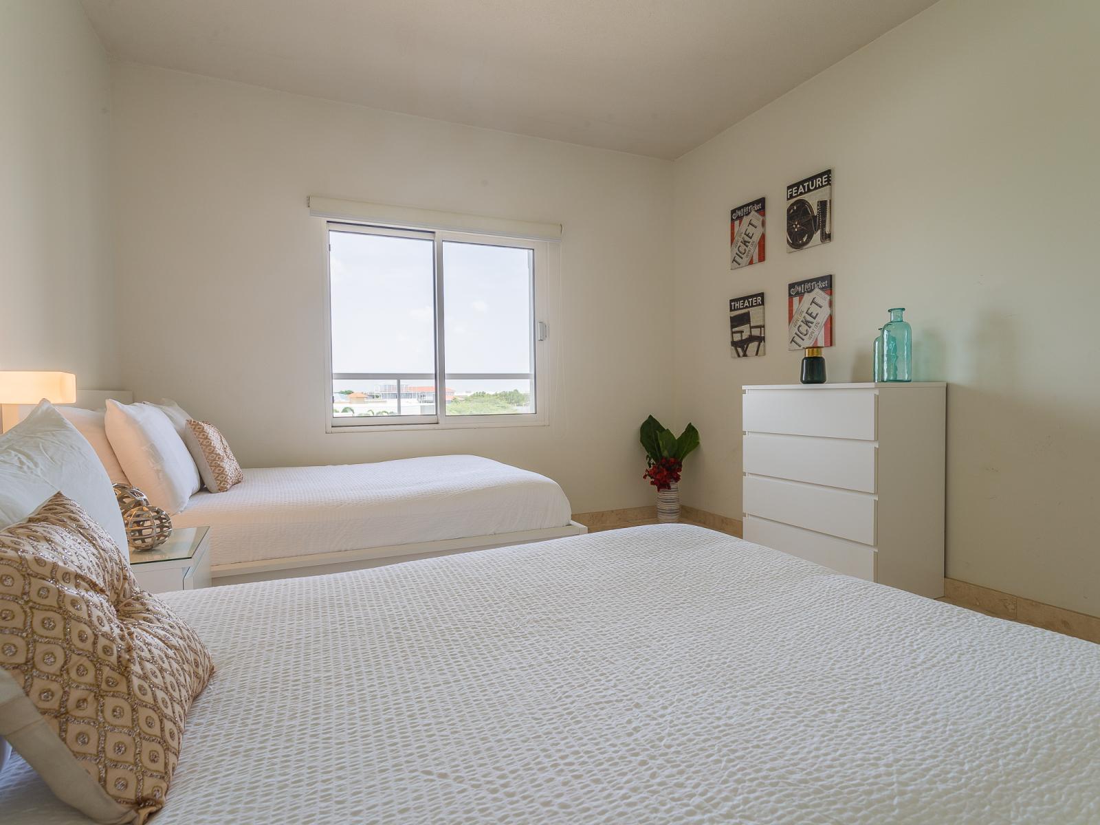 Welcome to Bedroom 2, your cozy haven featuring two full-size beds. Whether you're traveling with family or friends, our spacious accommodations offer ample space for a restful night's sleep and a comfortable retreat after a day of adventure.