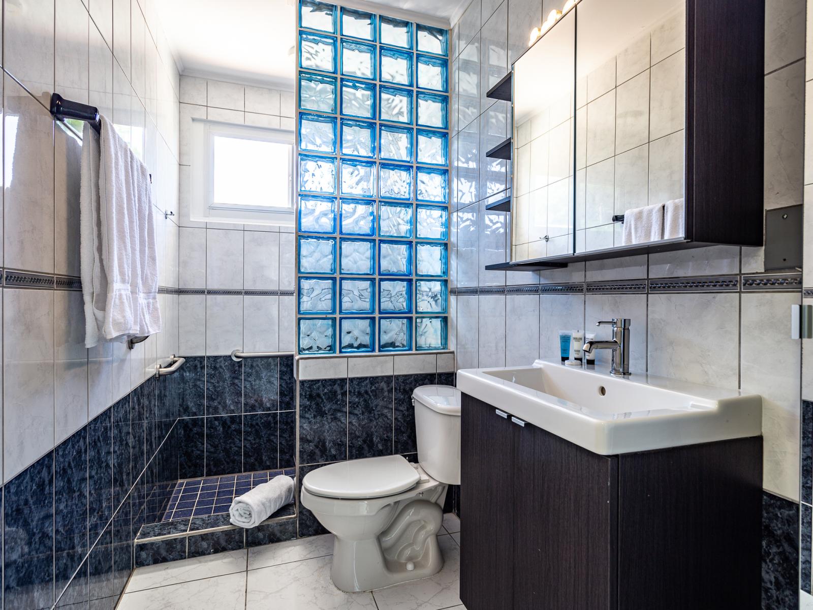 Bathroom 3 offers a luxurious walk-in shower, providing a refreshing and spa-like experience for your comfort and relaxation.