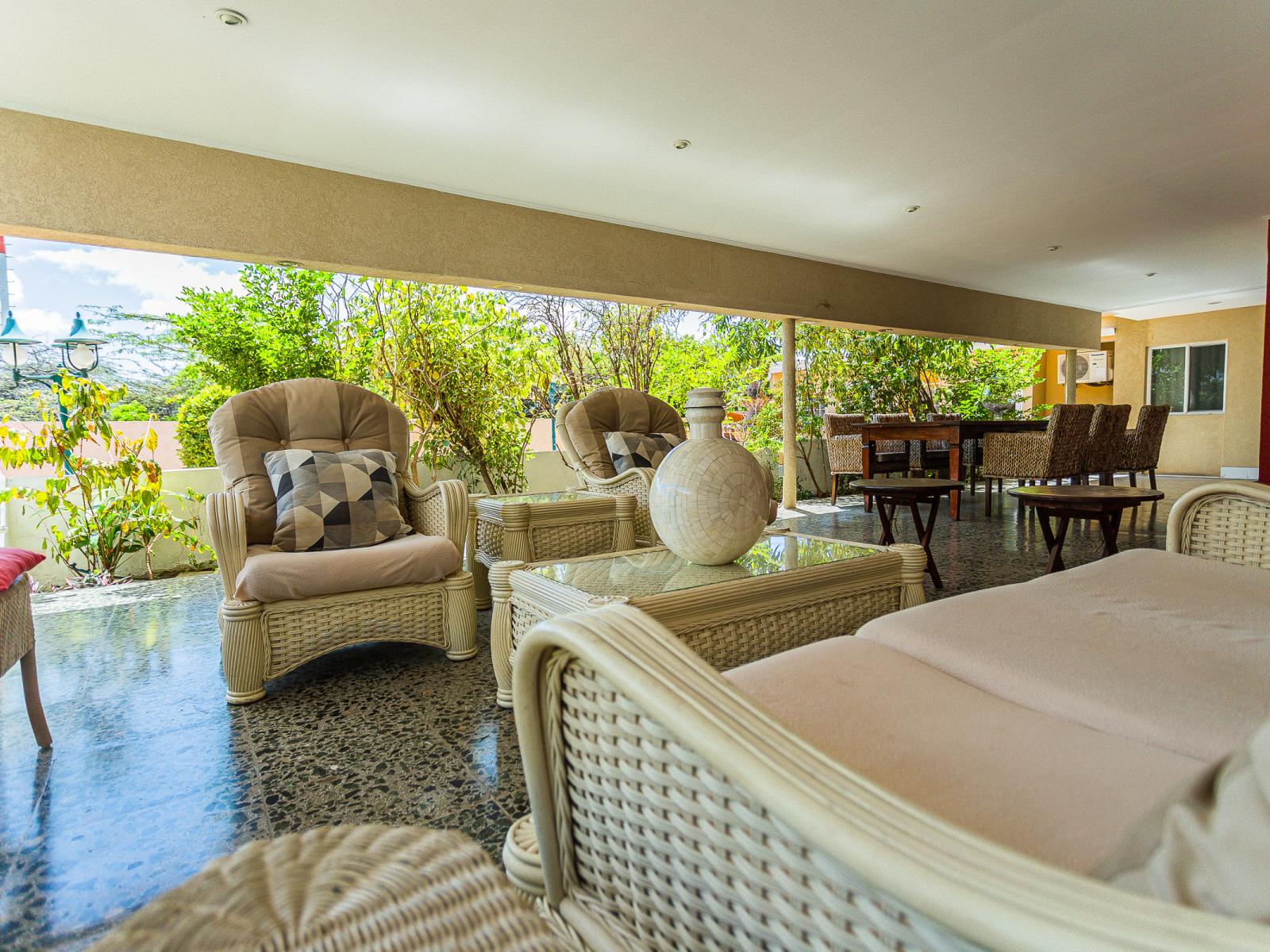 Escape the Heat: Relax in the Comfort of Your Shaded Outdoor Seating Area, Where Cool Breezes and Serenity Await.