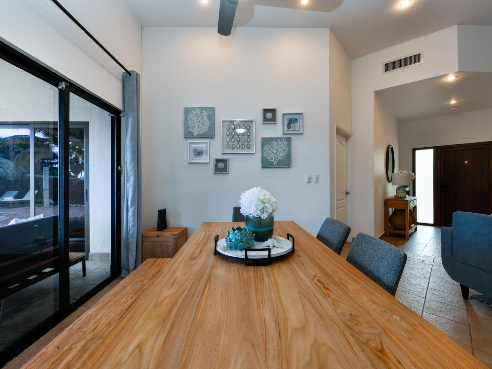 Dining table by sliding doors that connect to the backyard