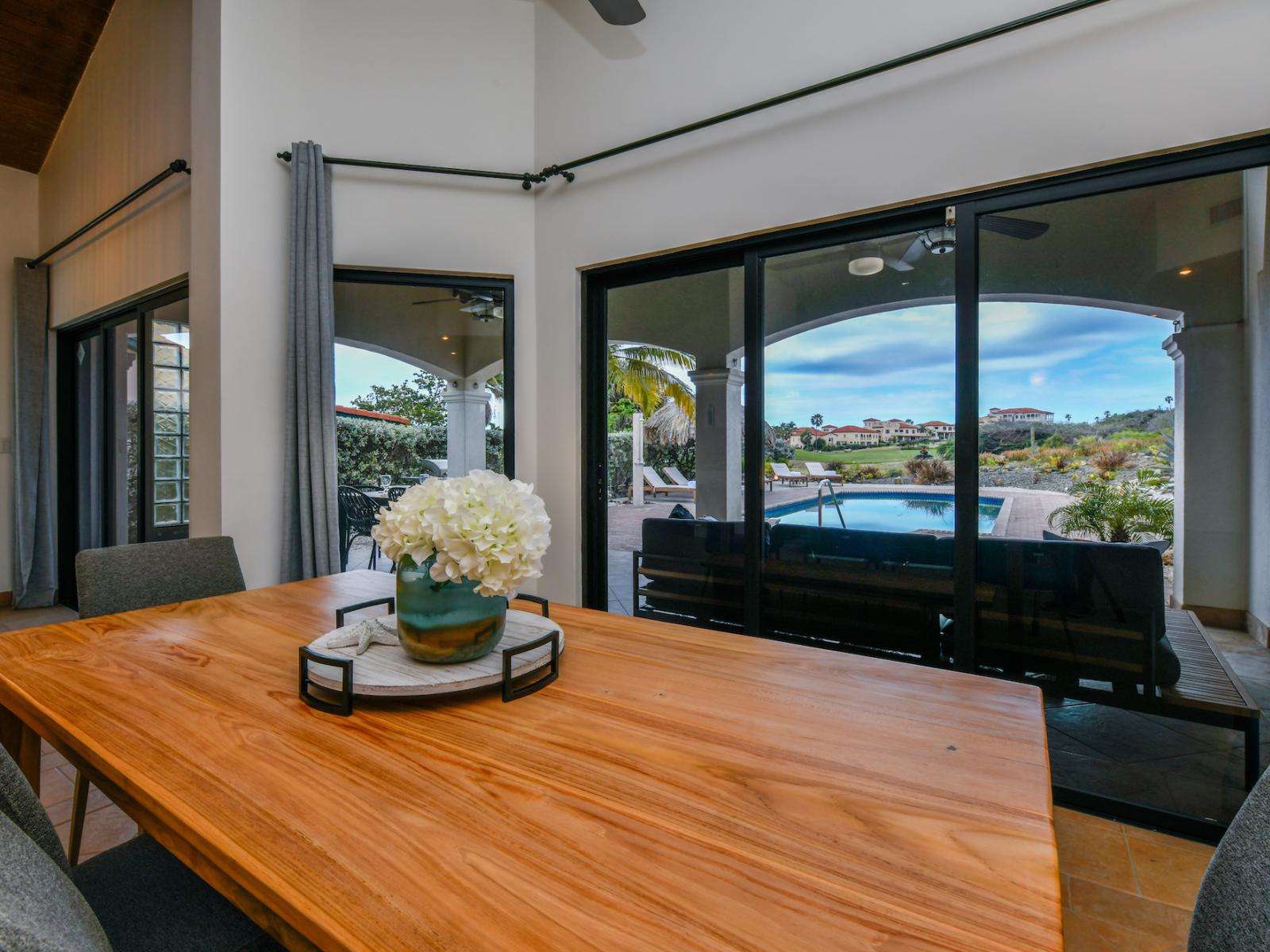 Dining table by sliding doors that connect to the backyard