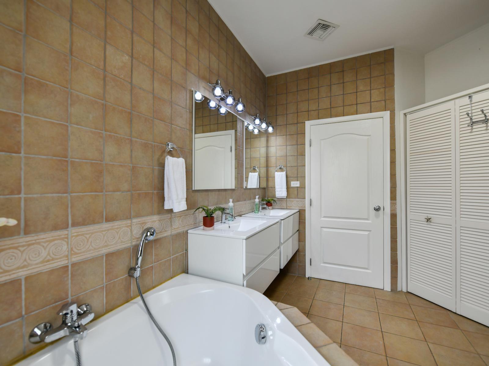 Bathroom 1 features a double vanity, a walk in shower and bath tub