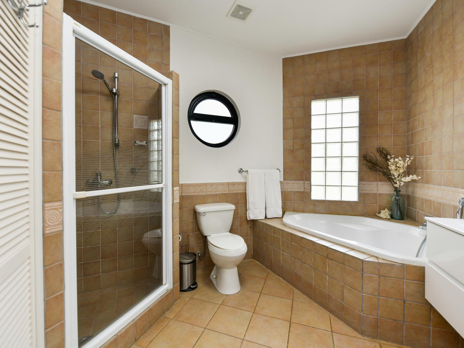 Bathroom 1 features a double vanity, a walk in shower and bath tub