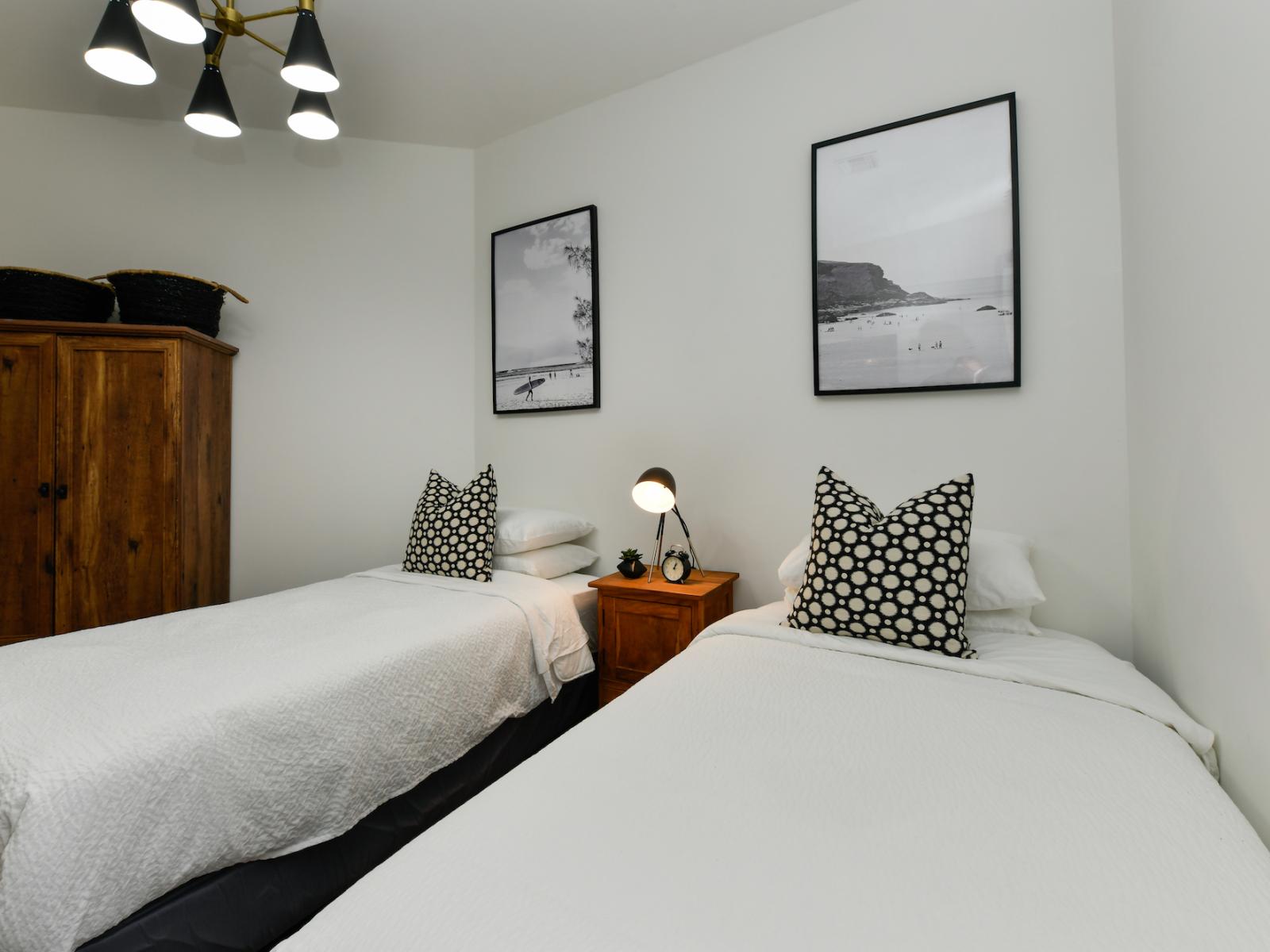 Perfect for friends or family: the second bedroom offers two single beds and an ensuite bathroom.