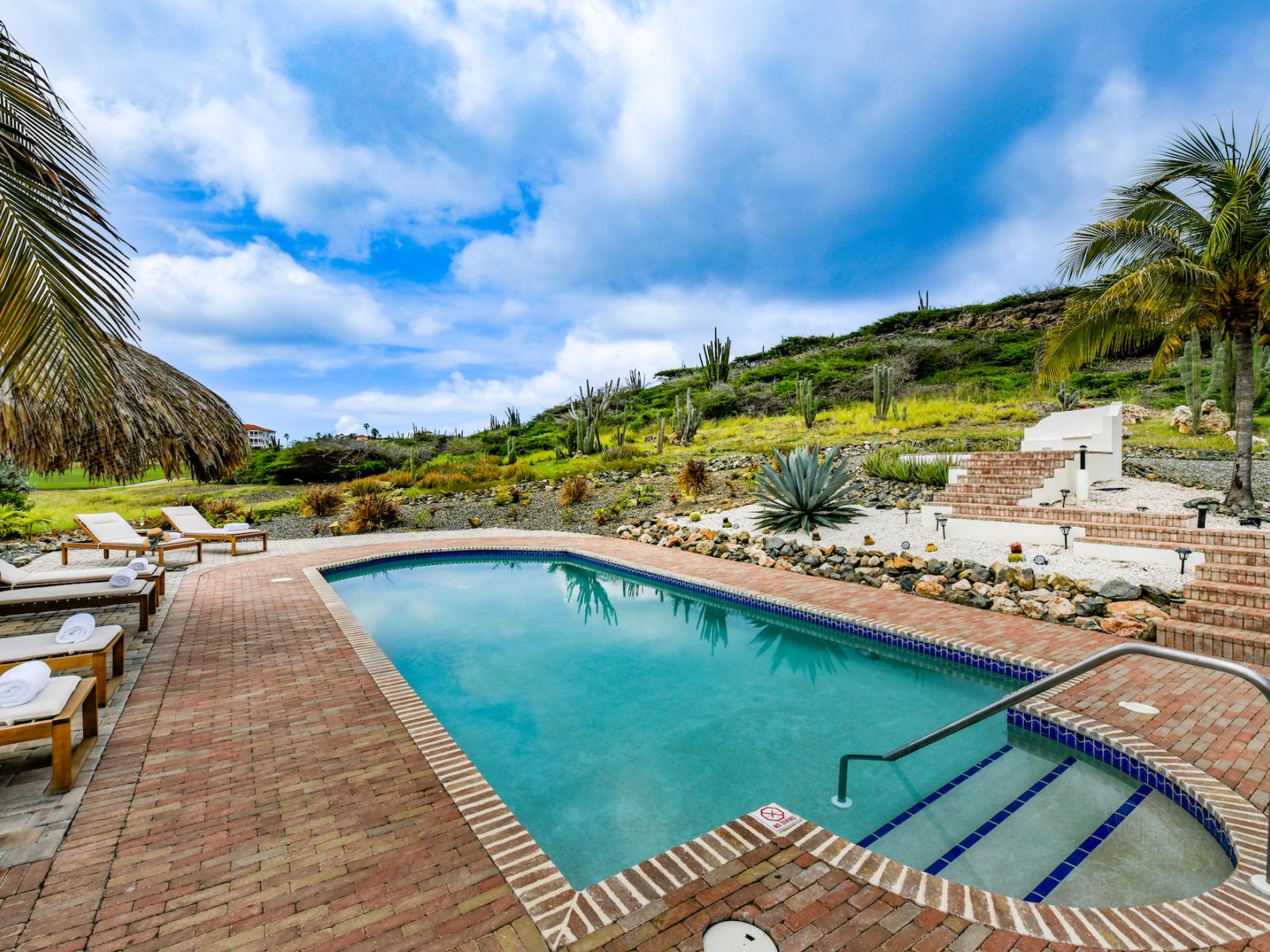 Amazing pool area of the villa in Noord, Aruba - Cosy beach chairs and neat and clean towels available - Beautiful mountain view - Superbly designed pool area - Refreshing Environment - Vibrant Atmosphere