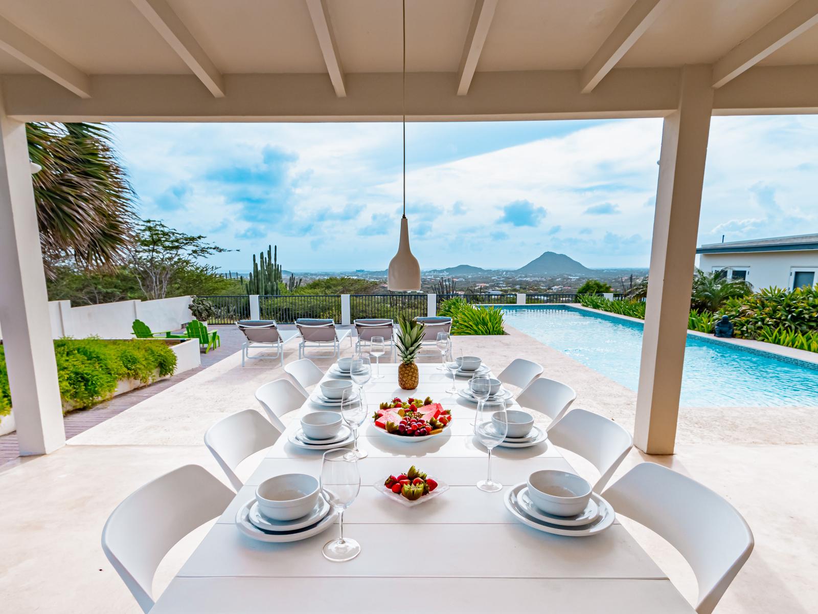 Wonderful dinning area of the Home in Santa Cruz, Aruba - 8 Persons Beautiful Dinning - Private terrace dinning space beside the glorious pool - Elegant Chandelier - Refreshing environment - Cosy beach chairs to relax - Soul enhancing space