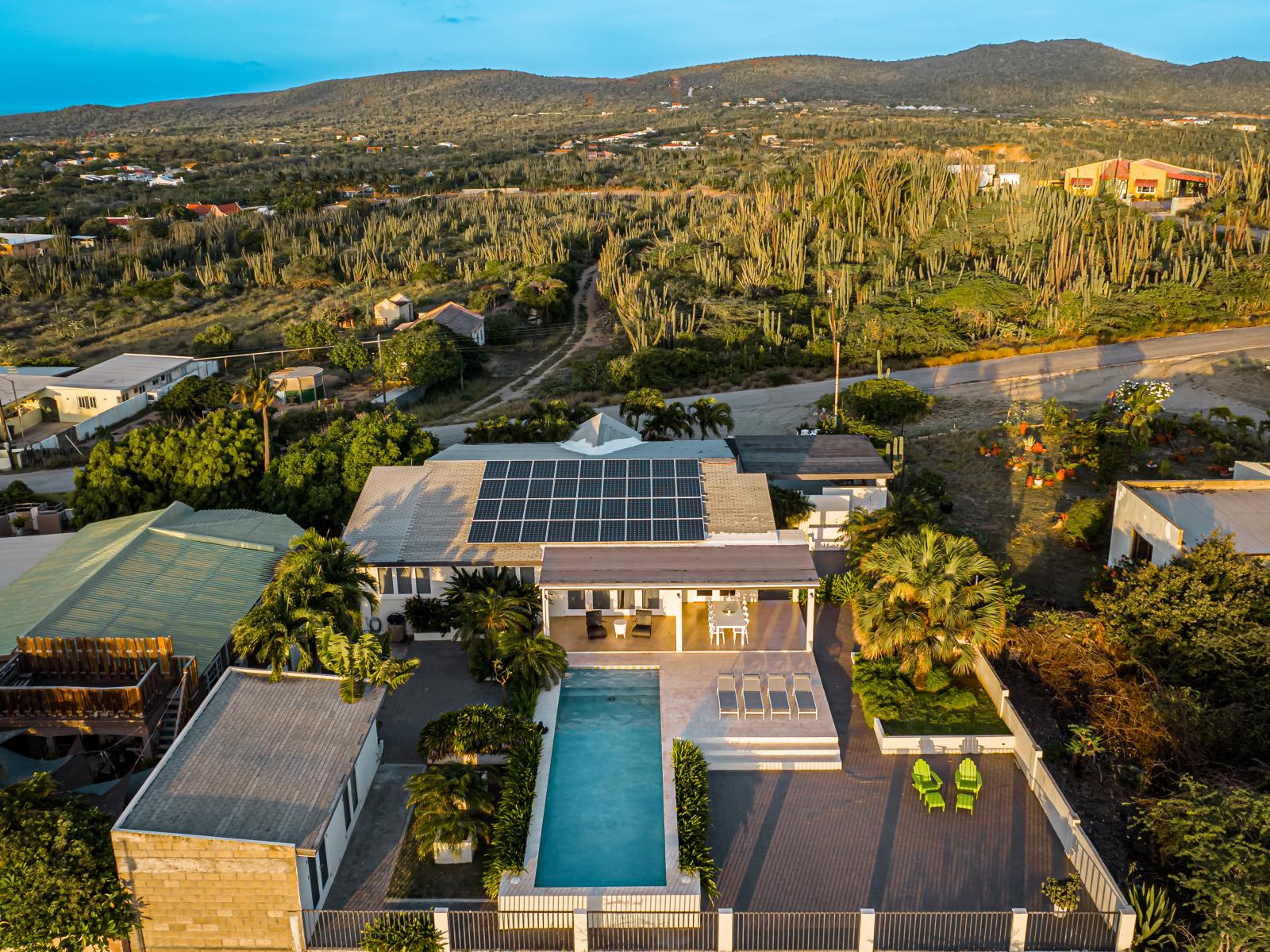 Stunning Home in Aruba - Bird eye Views - An abundance of greenery surrounding the villa - The Villa and its inviting pool area, - Harmoniously integrated into the lush natural surroundings