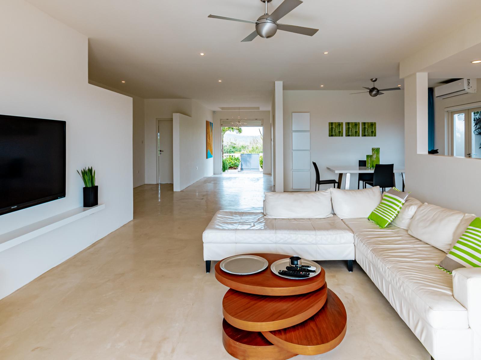 Spacious Living Area of the Home in Santa Cruz Aruba - Living room where comfort meets style - Luxurious Comfy Sofas - Functional and aesthetically pleasing space for relaxation - Smart TV and Netflix