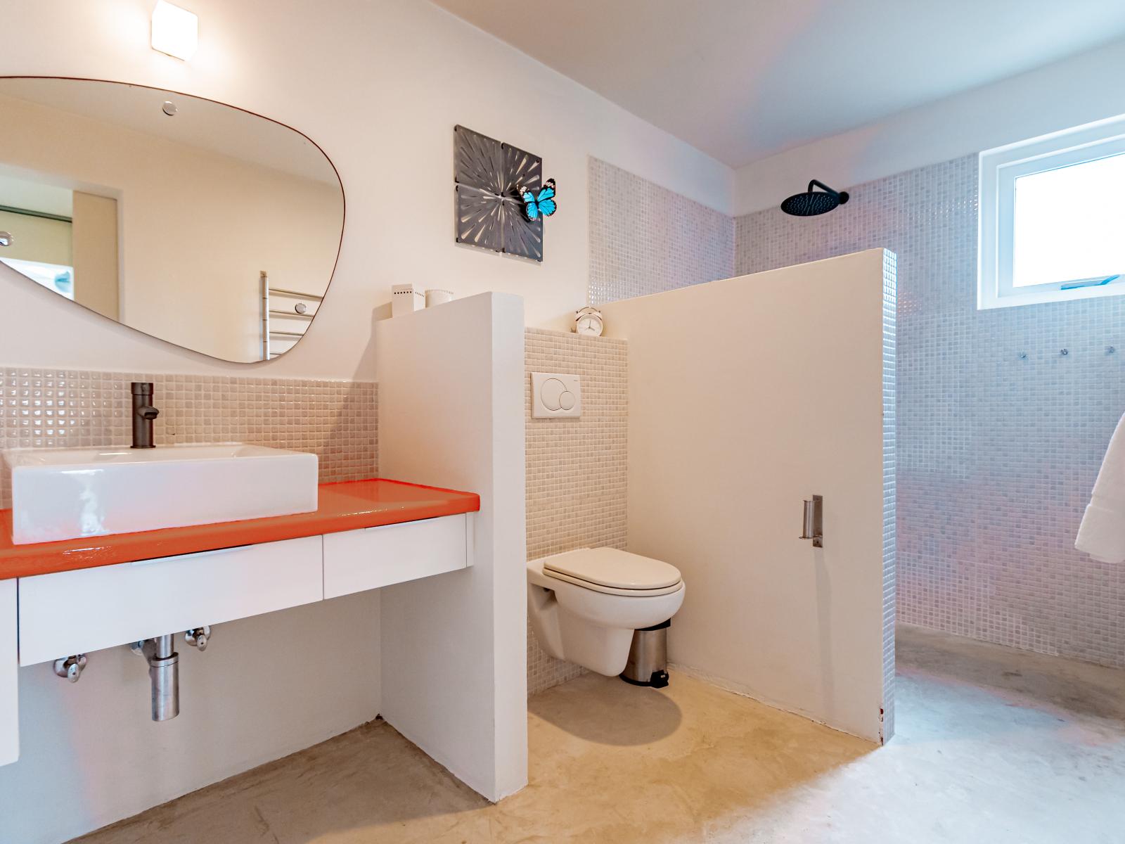 Classy Bathroom of the Home in Santa Cruz, Aruba - Neat and clean toilet seat - Great lighting - Beautiful Vanity with large size wall mirror - Availability of all Bathroom amenities - Elite Separate Shower area