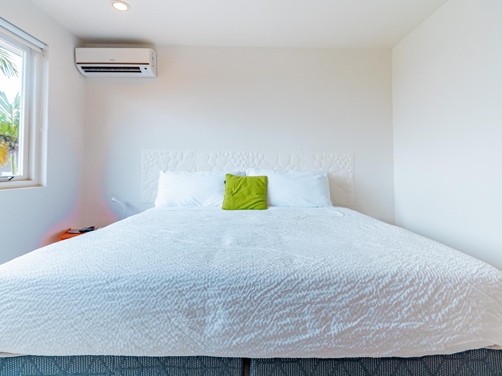 Spacious Bedroom of the Home in Santa Cruz Aruba - Comfortable bed - Elegant Lighting and Black out Curtains - Minimalist decor, allowing the focus to remain on the dining experience