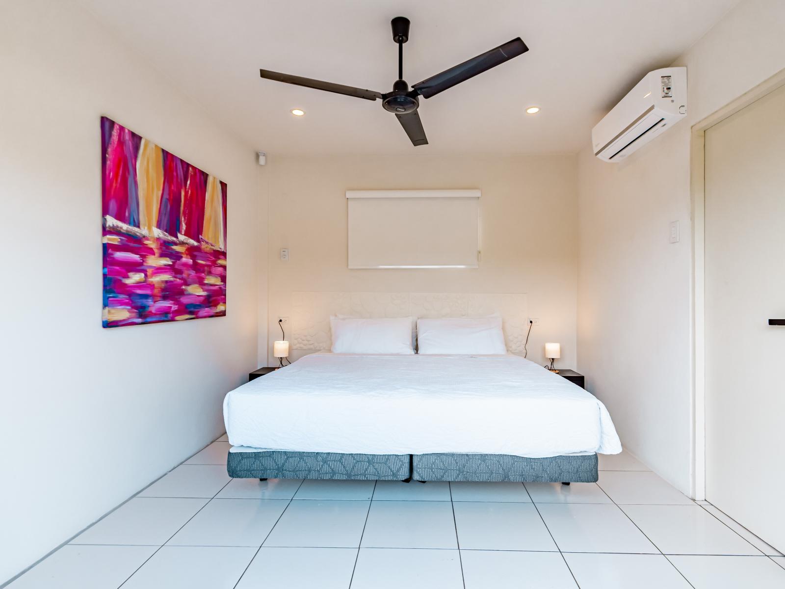 Sublime Bedroom of the Home in Santa Cruz, Aruba - Cozy King size Bed - Stunning large window of the bedroom with mesmerising views - Beautiful large aesthetic wall painting - Majestic Table lamps - Full light and airy room of the apartment