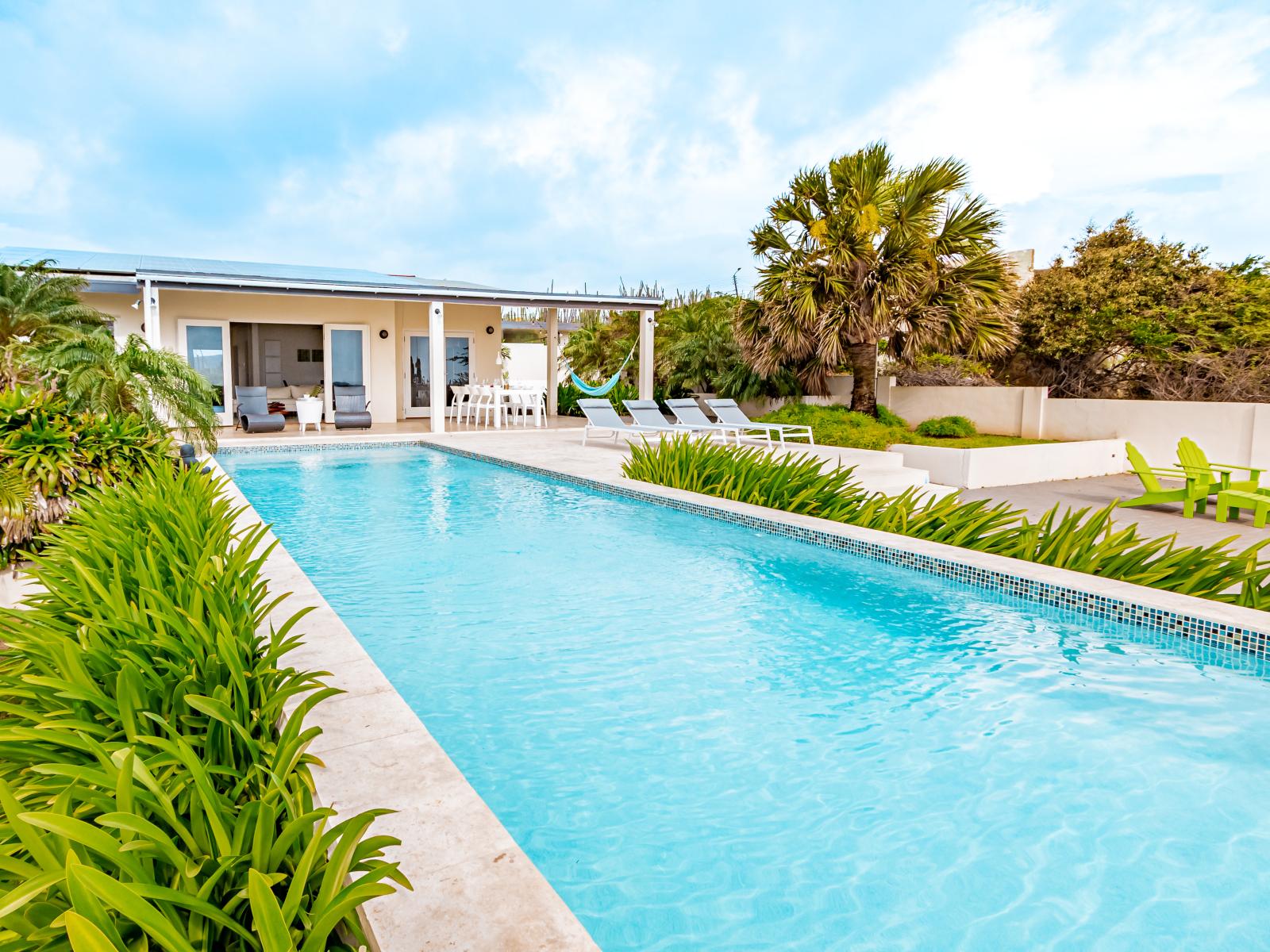 Resplendent Private Pool Area of the Home in Santa Cruz Aruba - Experience ultimate relaxation in poolside paradise - Discover bliss by the pool in  serene setting - Inviting pool area for a perfect getaway - Surrounded by tropical Trees