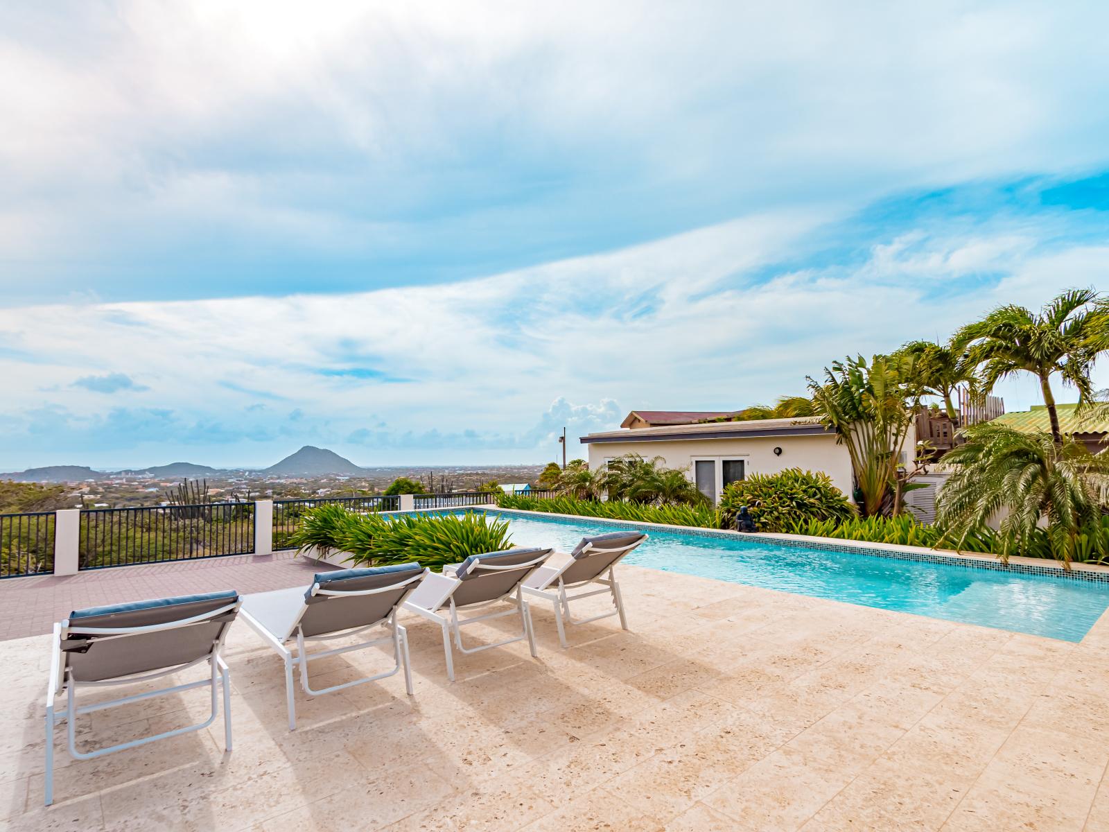 Lavish Pool Area of the Home Santa Cruz Aruba - Provides a relaxed atmosphere for unwinding - Designed with visual charm through landscaping - Ideal for swimming laps and water workouts - Comfy Beach Chairs