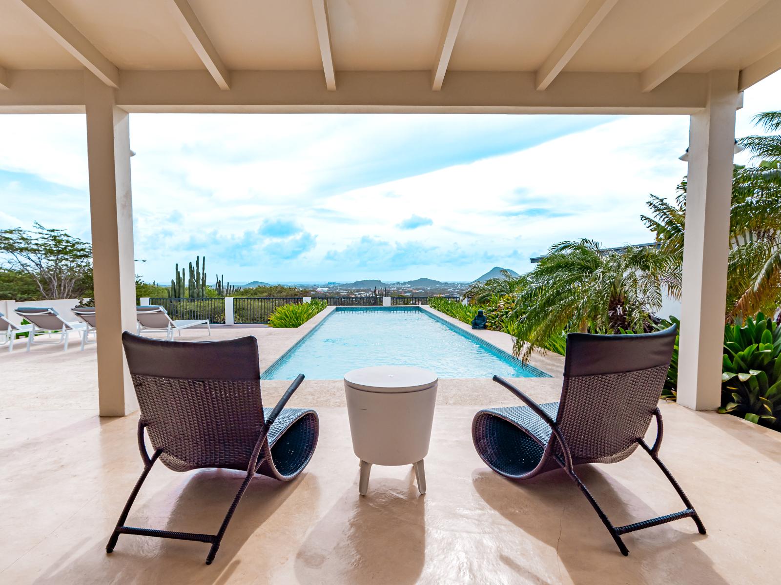 Luxury pool area of the Home in Santa Cruz Aruba - Shaded outdoor seating area - Beautifully sunbathed space makes the soul peaceful - Experience the comfort at the best