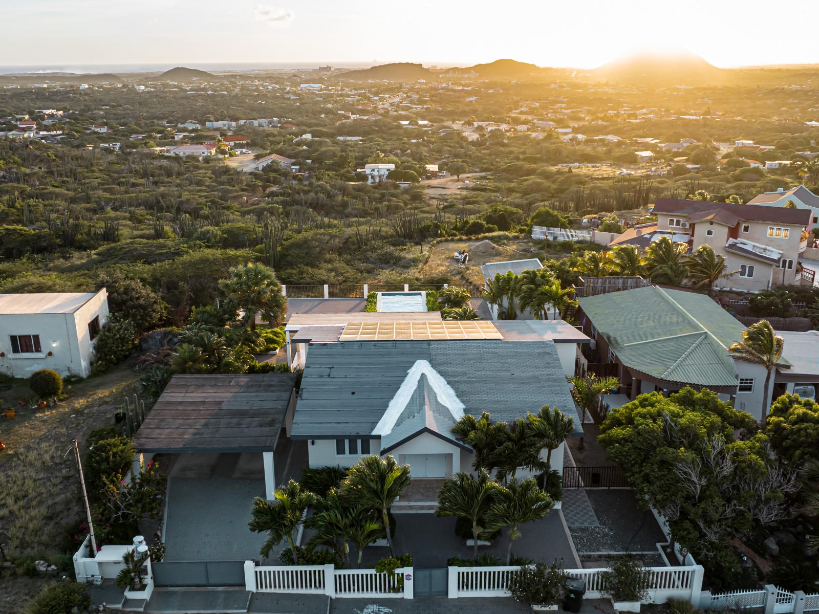 Experience a stunning Home in Aruba - Breathtaking bird's eye views - Surrounded by abundant greenery - This Home offers a serene atmosphere - Enjoy the inviting pool area  - The harmonious integration into lush natural surroundings