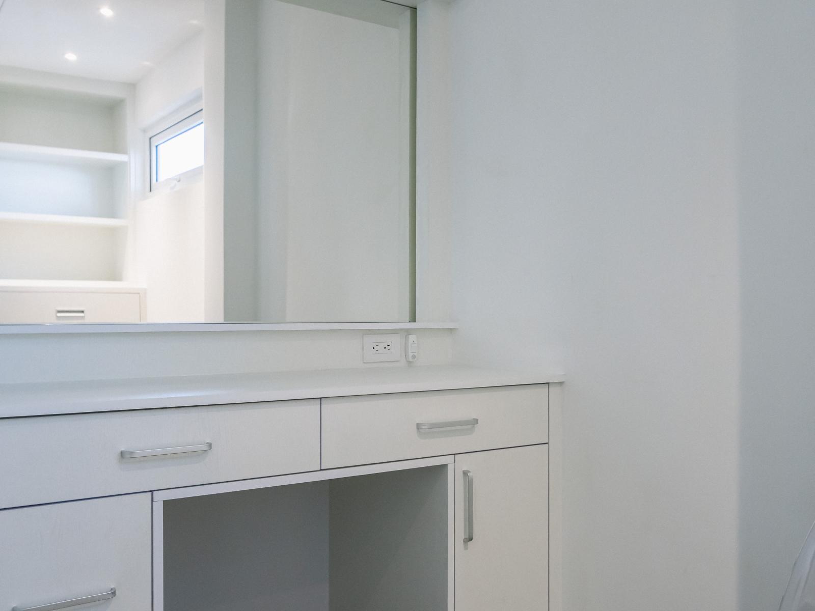 Bedroom 1 has a large walk in closet with a vanity