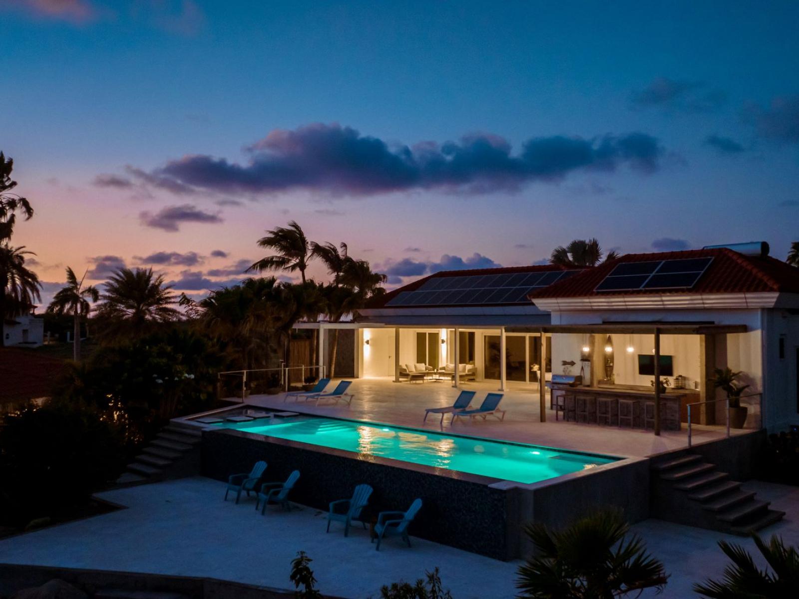 Backyard at night with timed pool lights