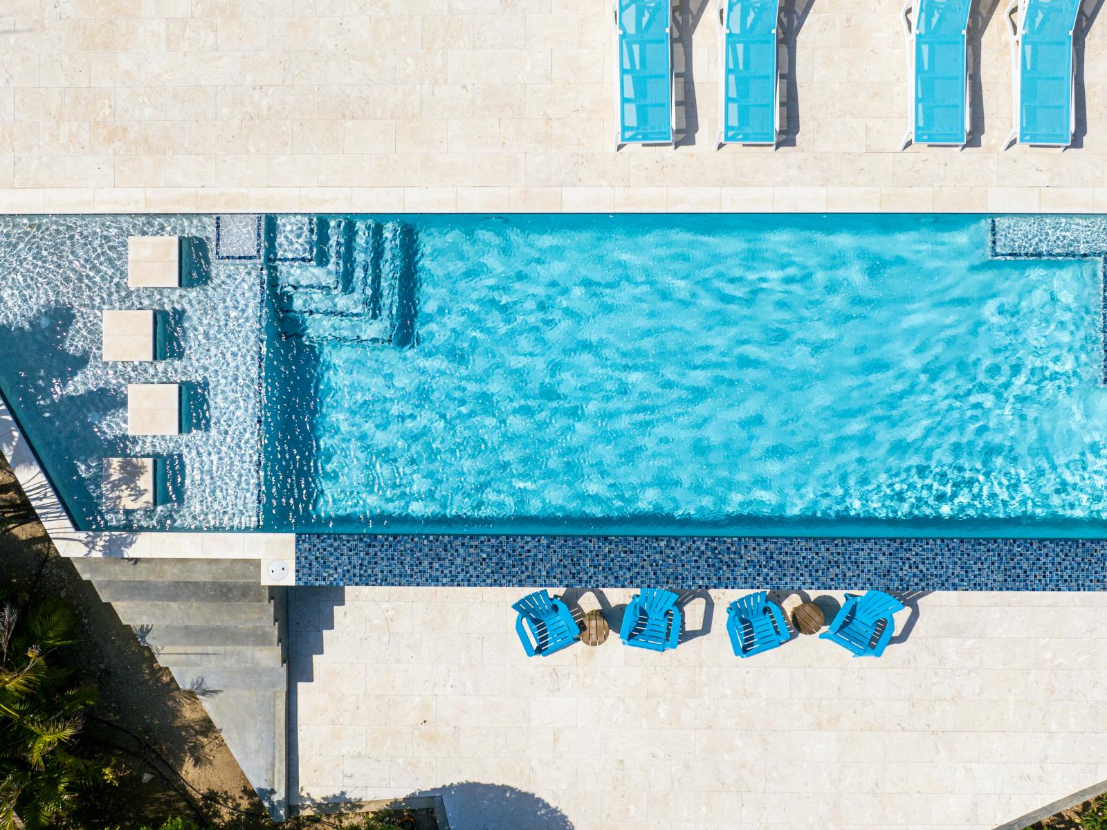 Refreshing pool with lots of lounge chairs