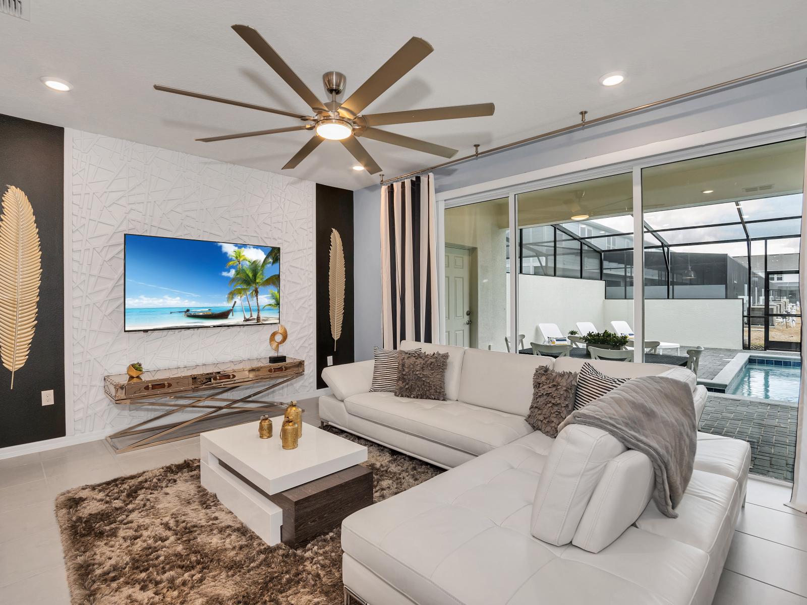 The living room offers a seamless view of the private pool outside, creating a tranquil ambiance that blurs the lines between indoor comfort and outdoor serenity.