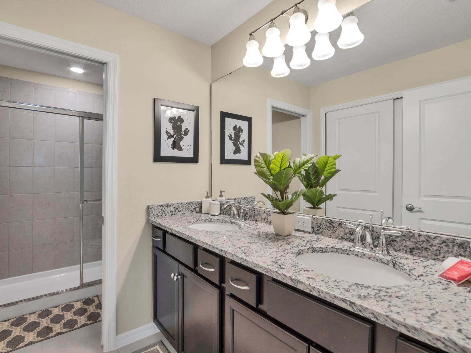 Behold the bathroom with its sleek shower enclosure, embodying modern elegance and functionality.