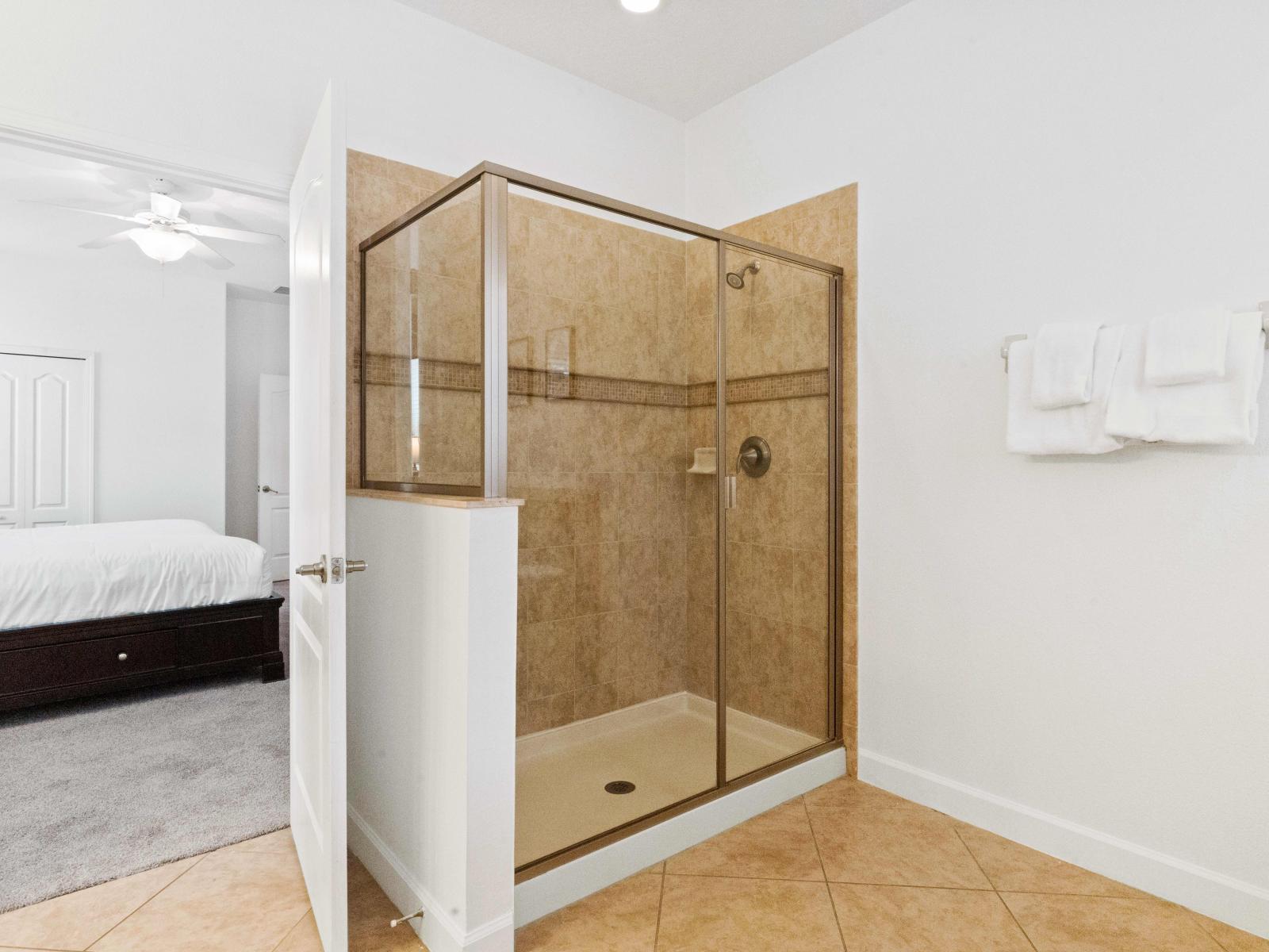 Modern and stylish ensuite bathroom which features a glass stall shower.