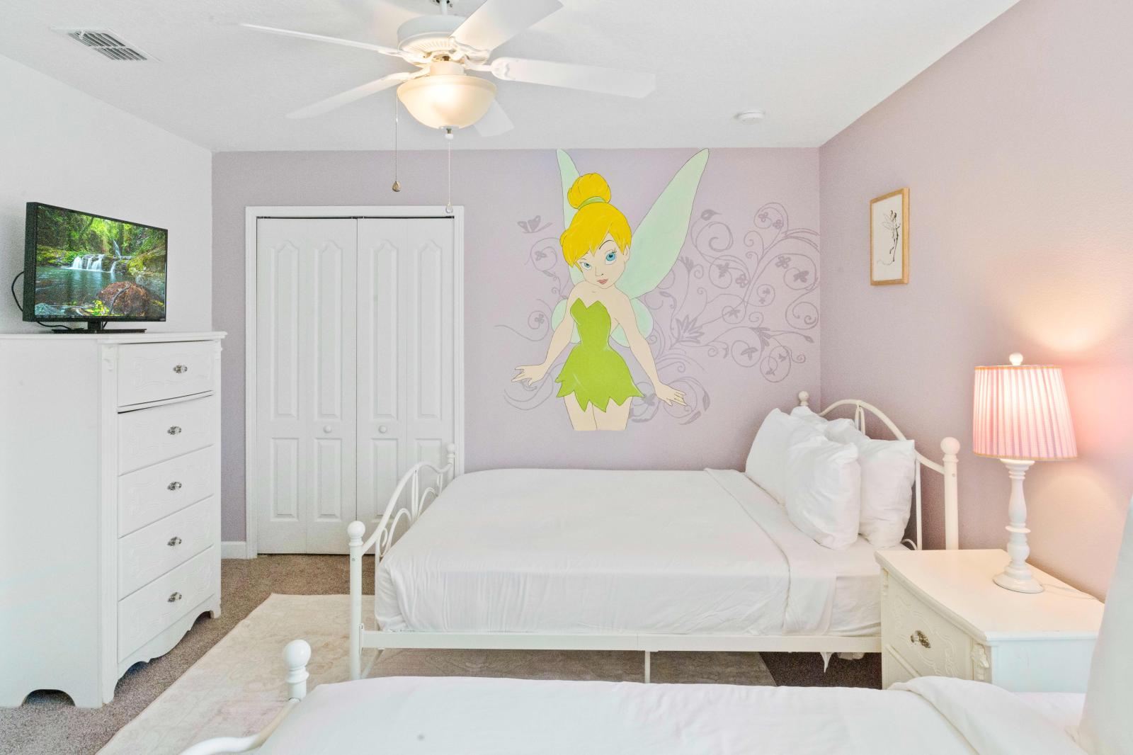Featuring a twin size bed, queen size bed, tall pristine dresser, and delicate fairy motif upon the wall, this bedroom is ideal for your little princesses.