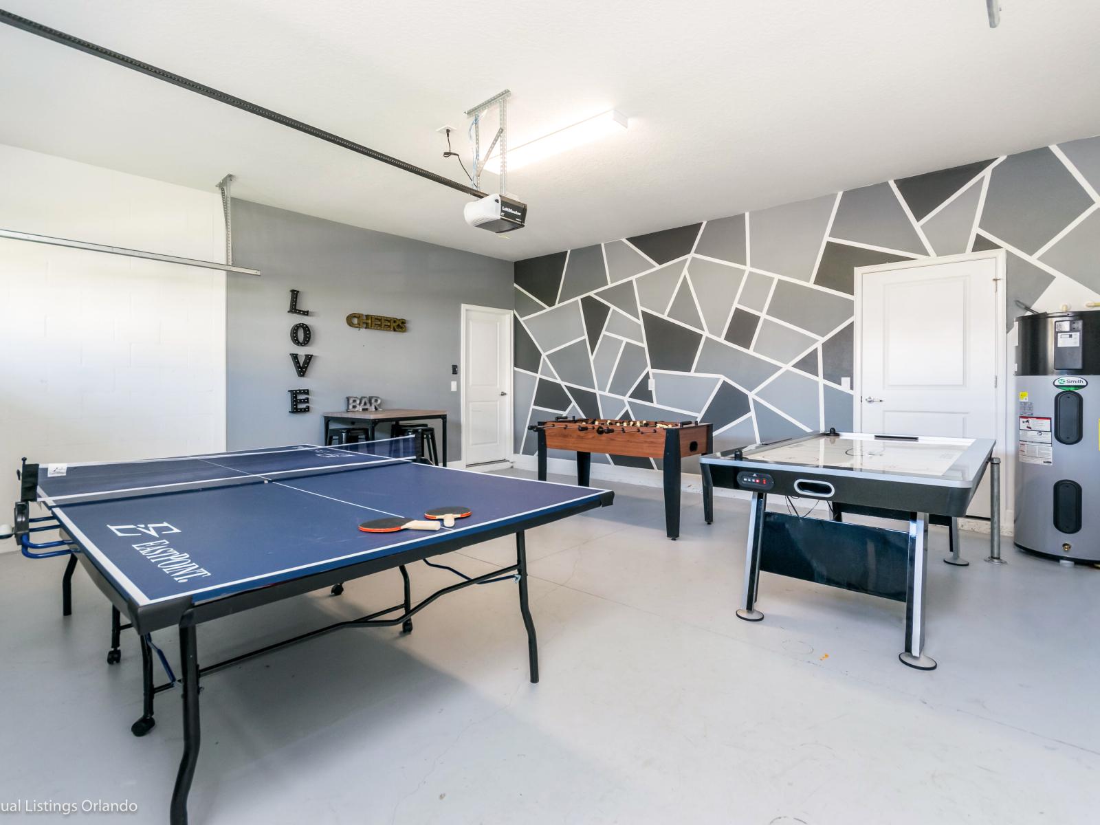 Refreshing Game Room of the Home in Davenport Florida - You can experience endless hours of family fun in the game room - Where you'll find foosball, air hockey and ping pong tables